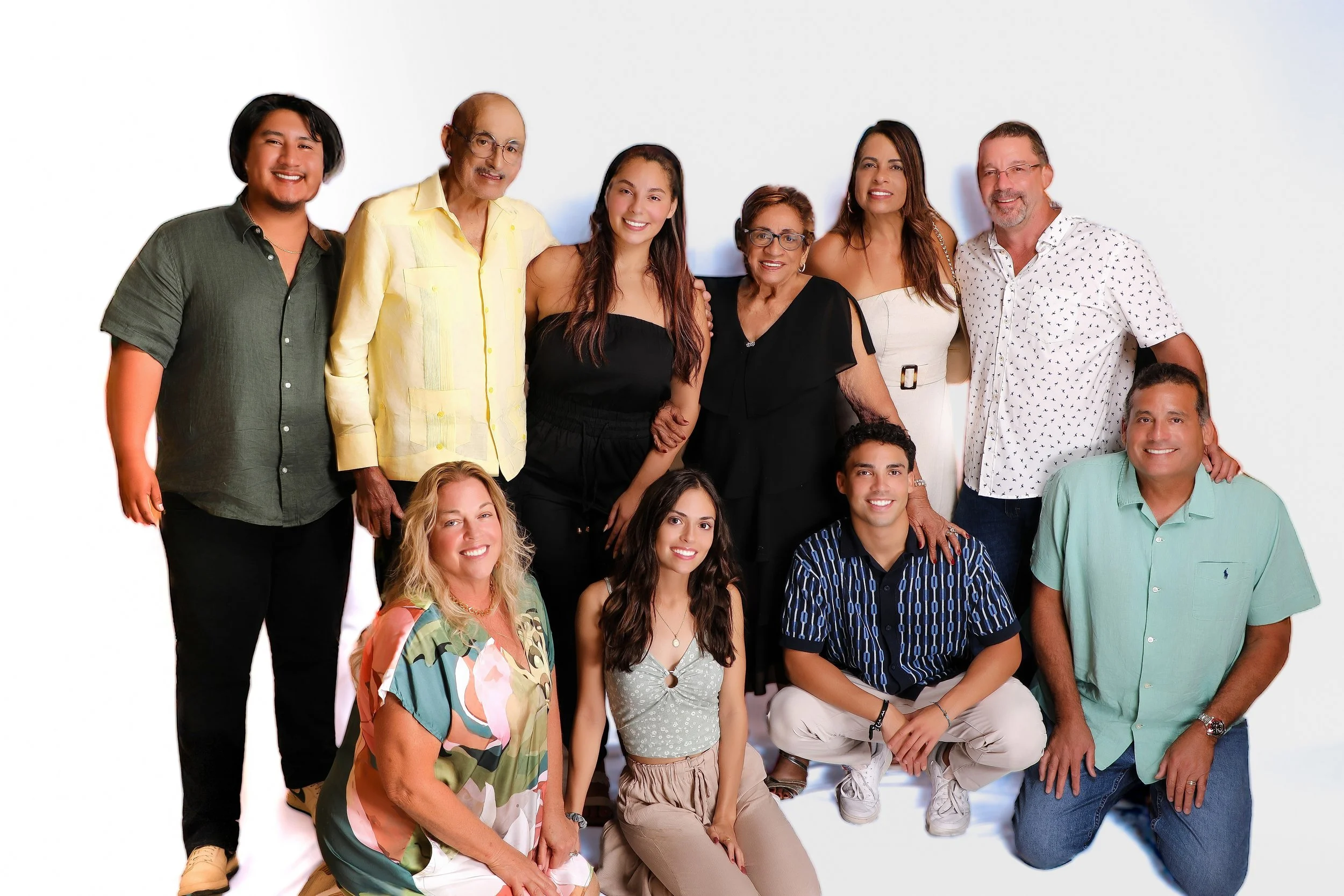 A diverse group of people smiling and posing together against a white background.