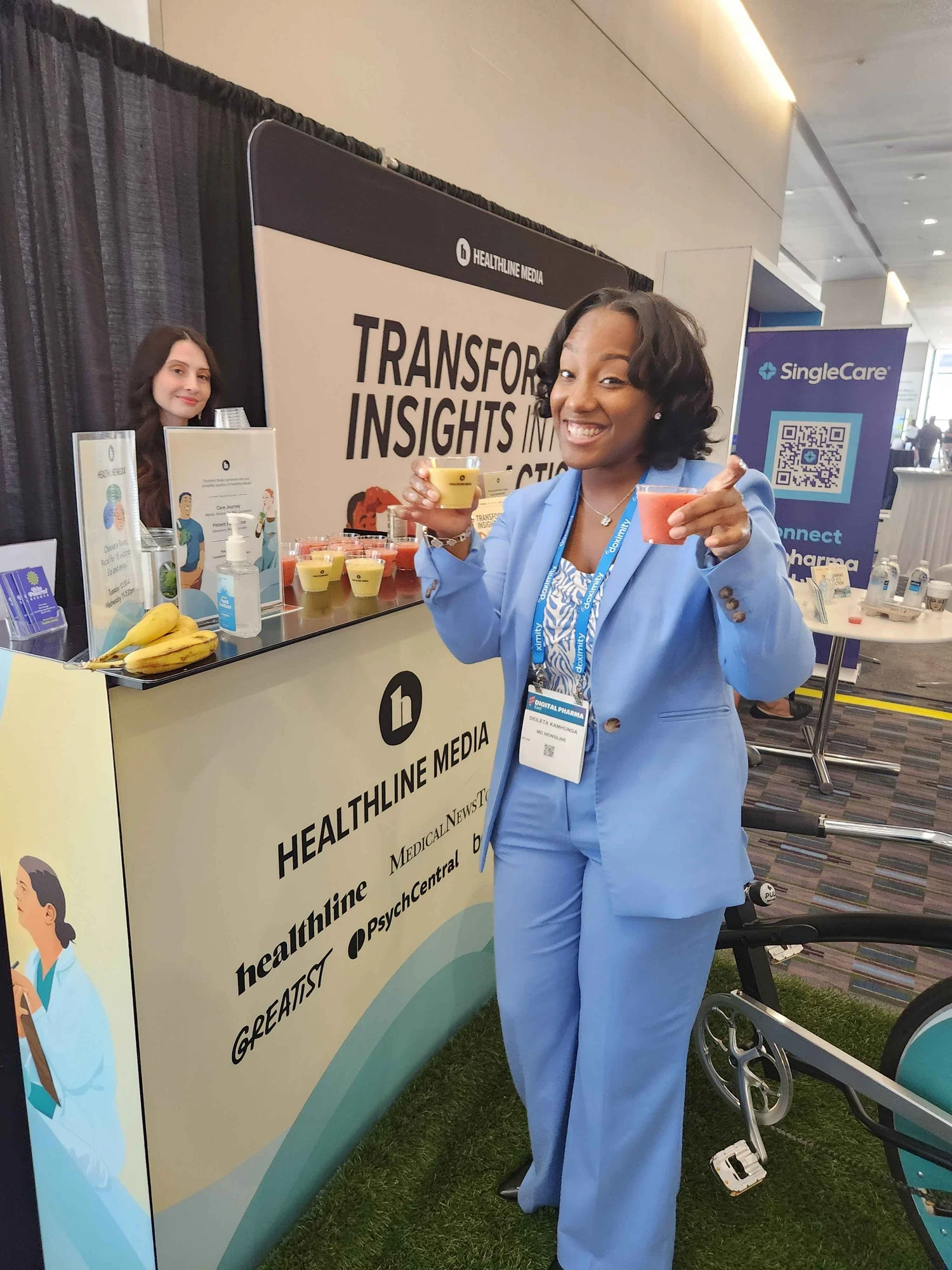 A guest smiling with a fresh smoothie at a health event