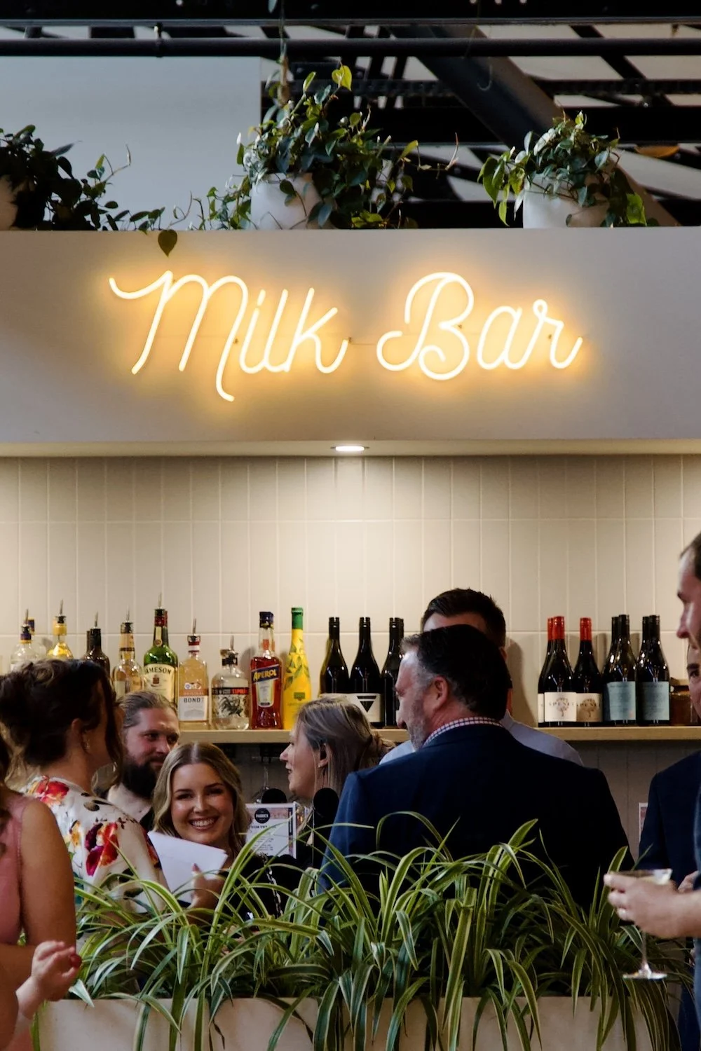 Guests mingling at Paddock Bakery Geelong’s Milk Bar, a vibrant venue for private events.