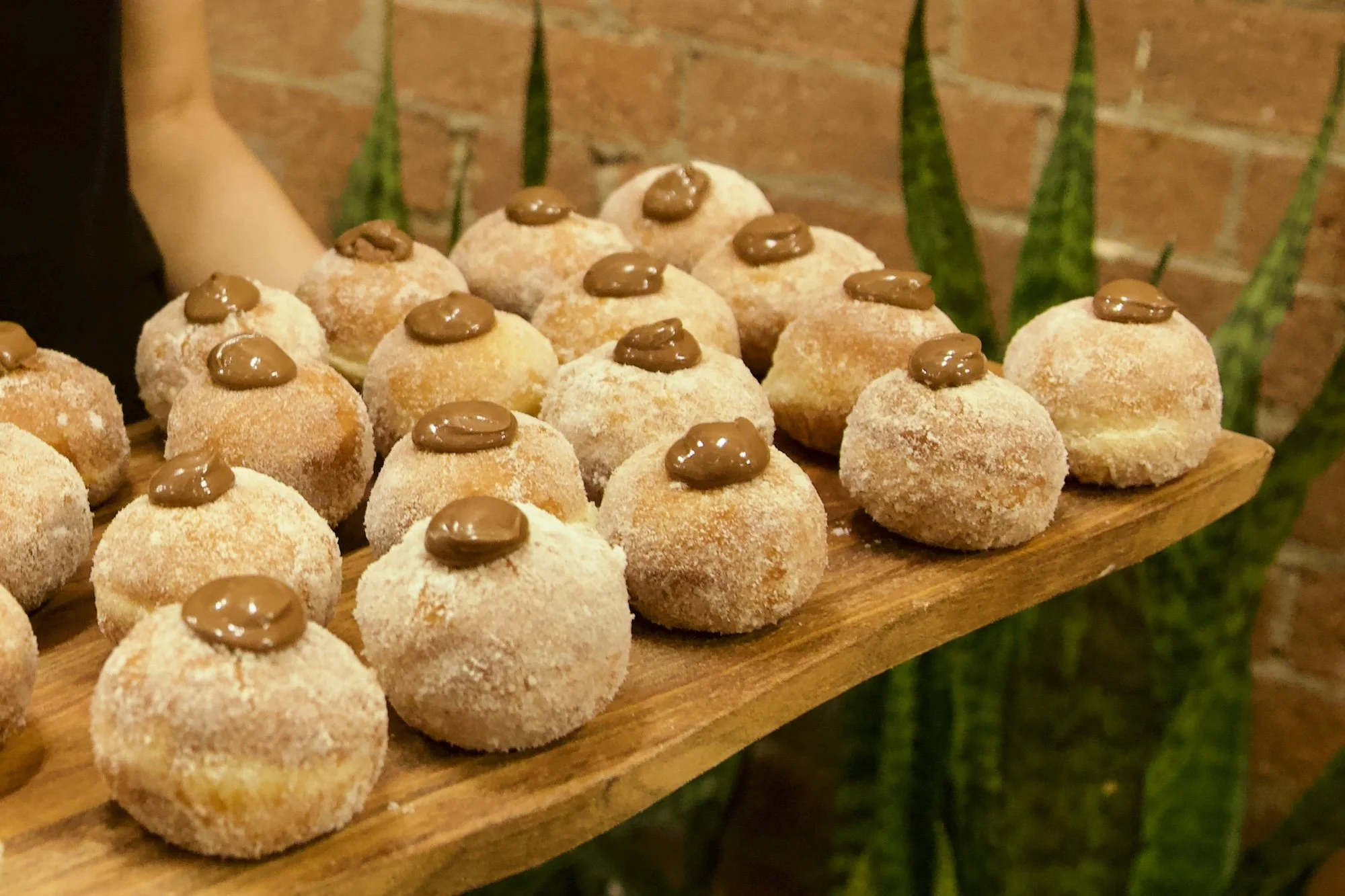 Nutella donut bot on rustic tray ideal for event dessert tables. 