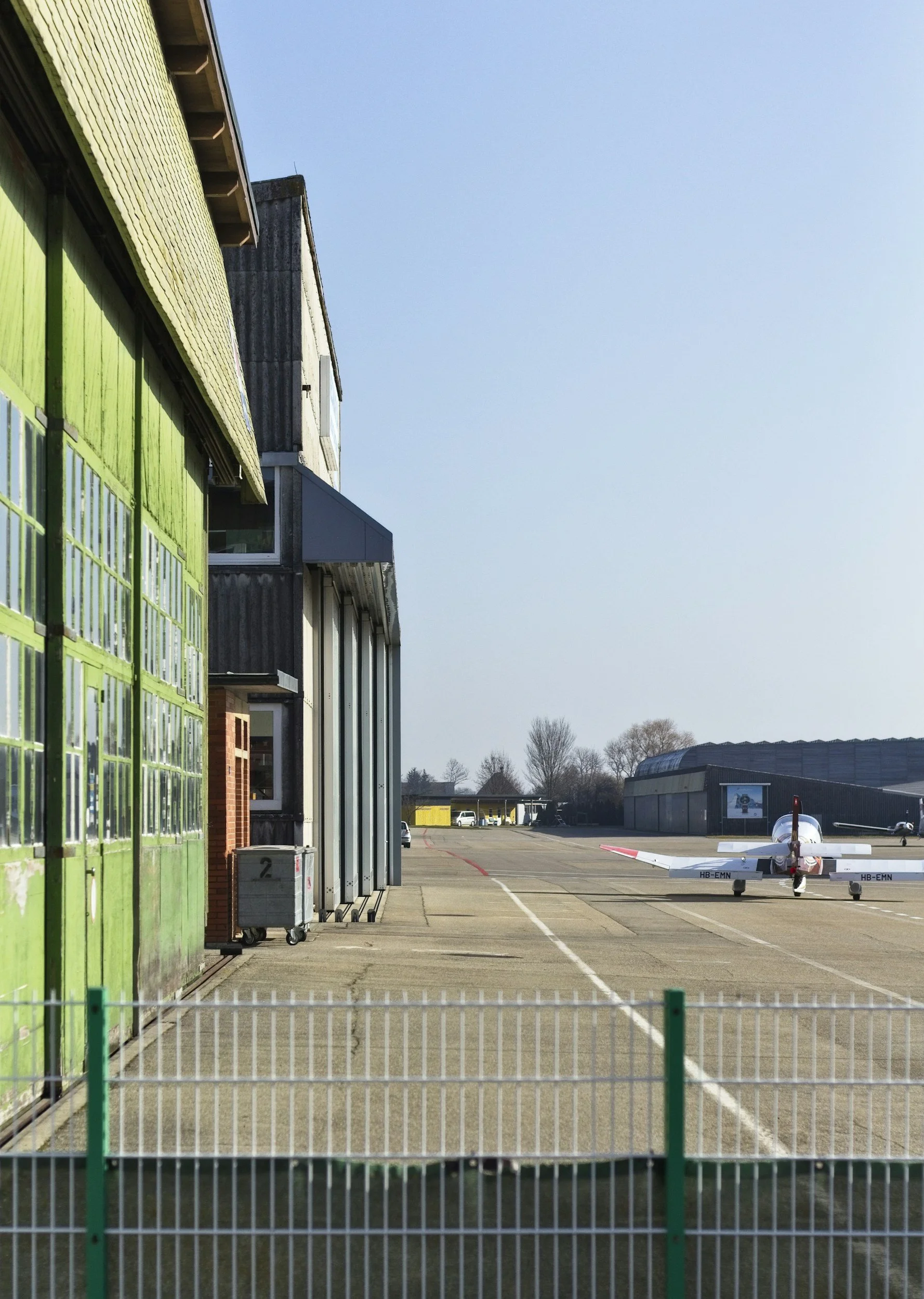 Airport service area with pavement markings beside an aviation building