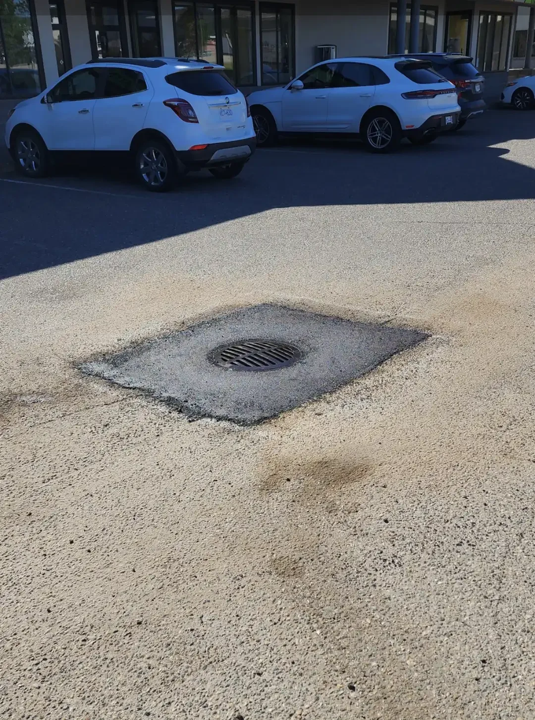 Close-up of an asphalt patch applied on top of damaged surface