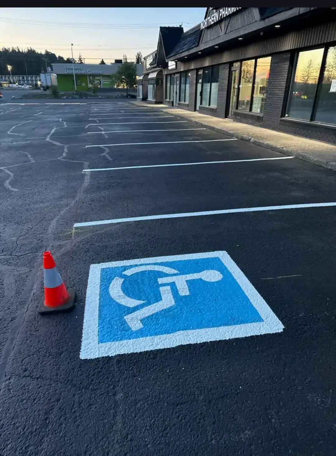 Sealcoated parking lot with fresh accessible parking marking at commercial property - Epic Pavement