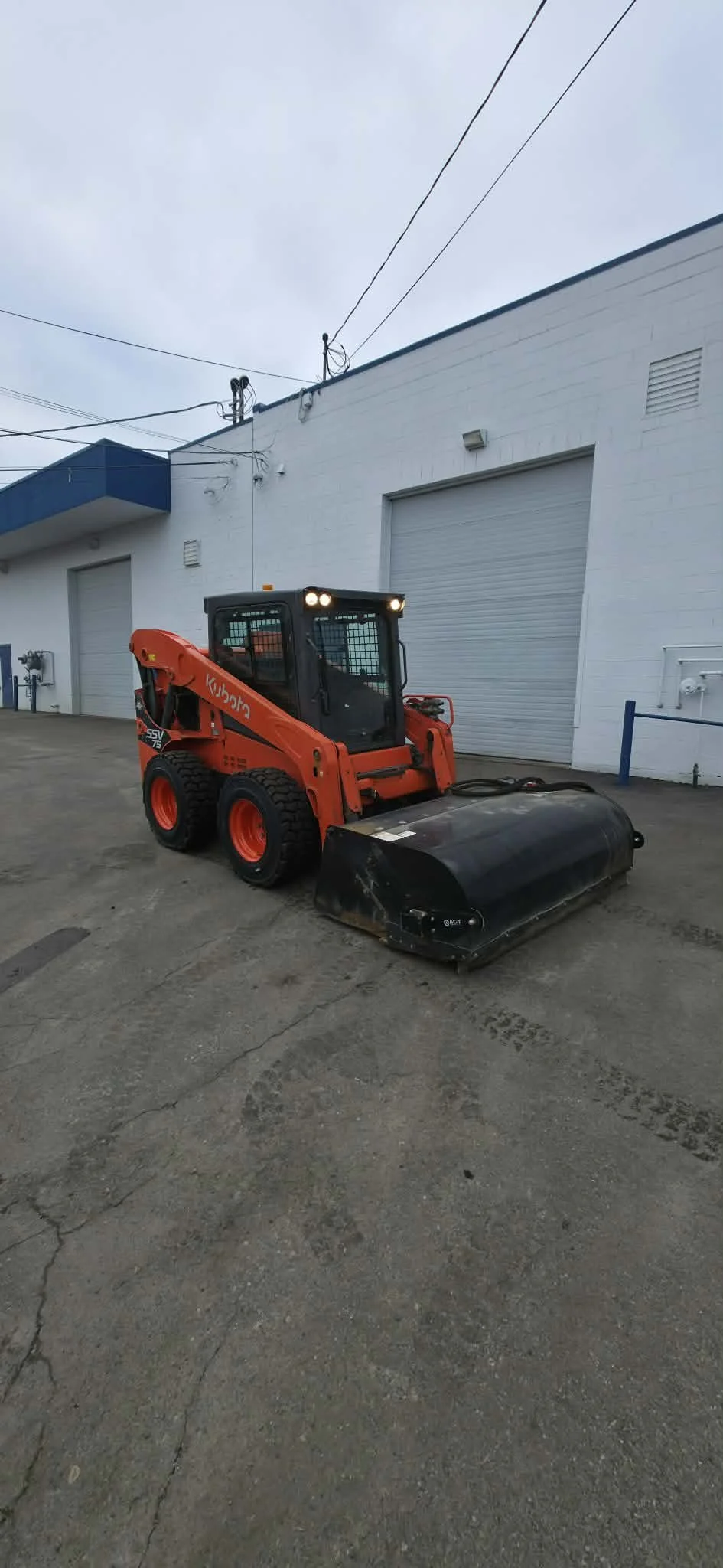 An aerial view of a clean commercial property with kubota cleaning equipment 