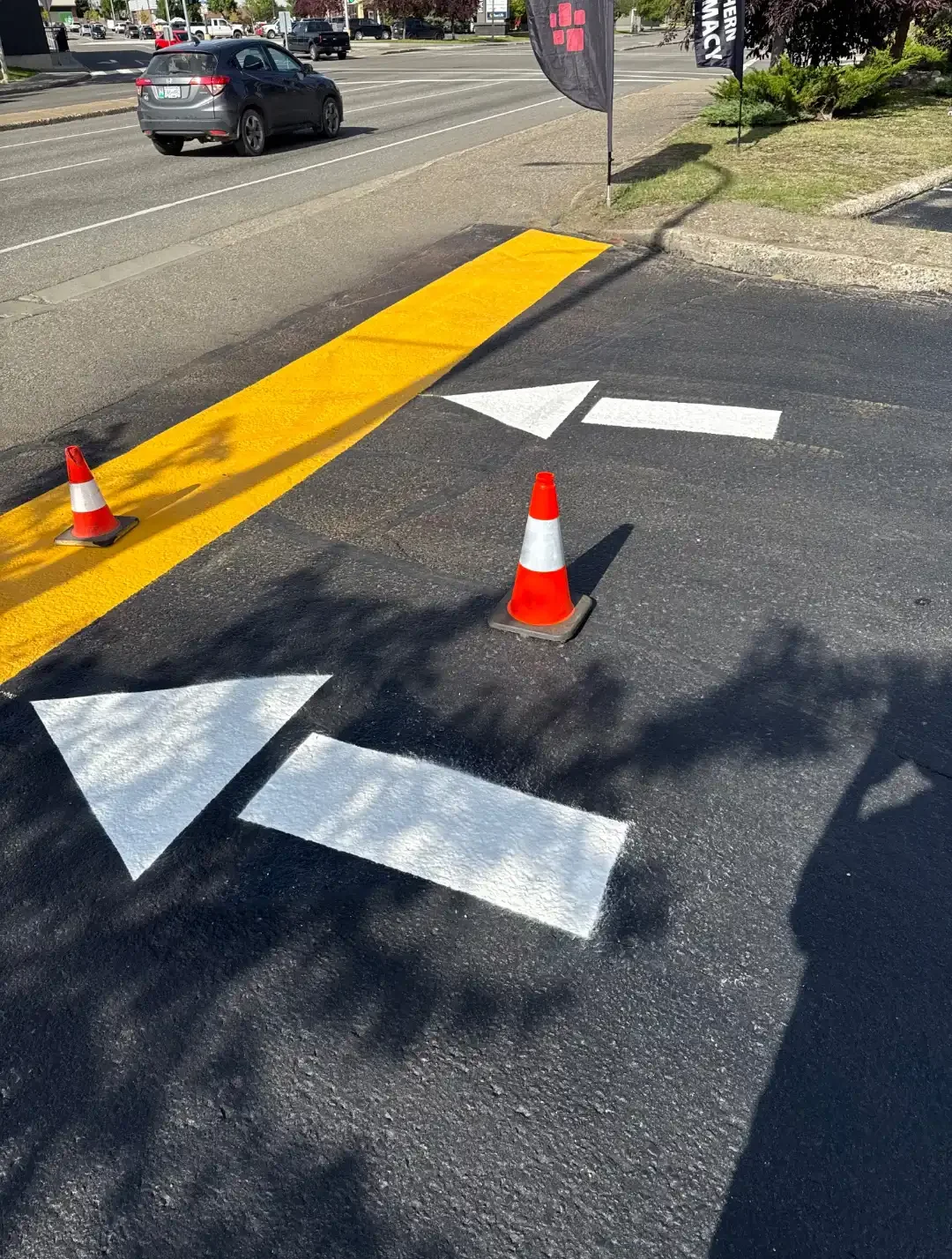 Parking lot line painting with directional arrows and curb marking - Epic Pavement