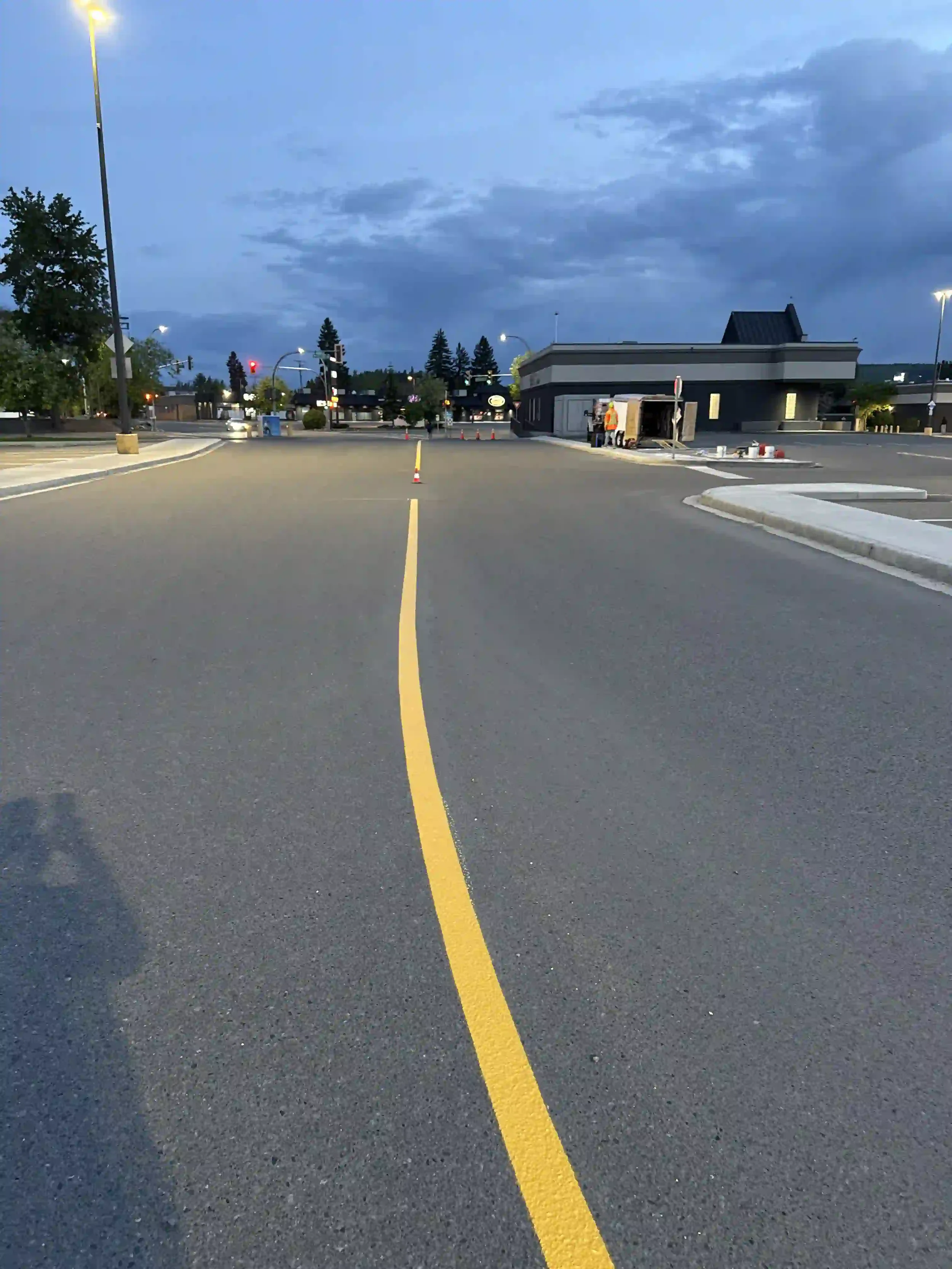 Expert parking lot striping services showing a straight, bright yellow center line for commercial traffic control in Grande Prairie, Alberta.