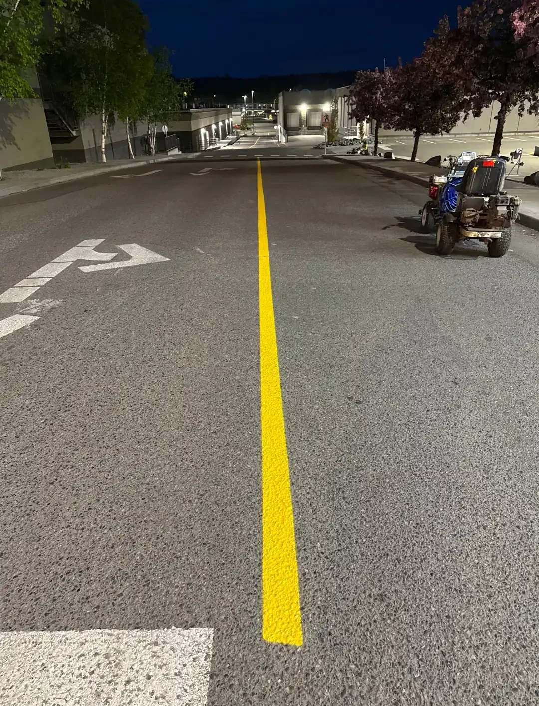 Fresh yellow center line marking on commercial asphalt roadway - Epic Pavement
