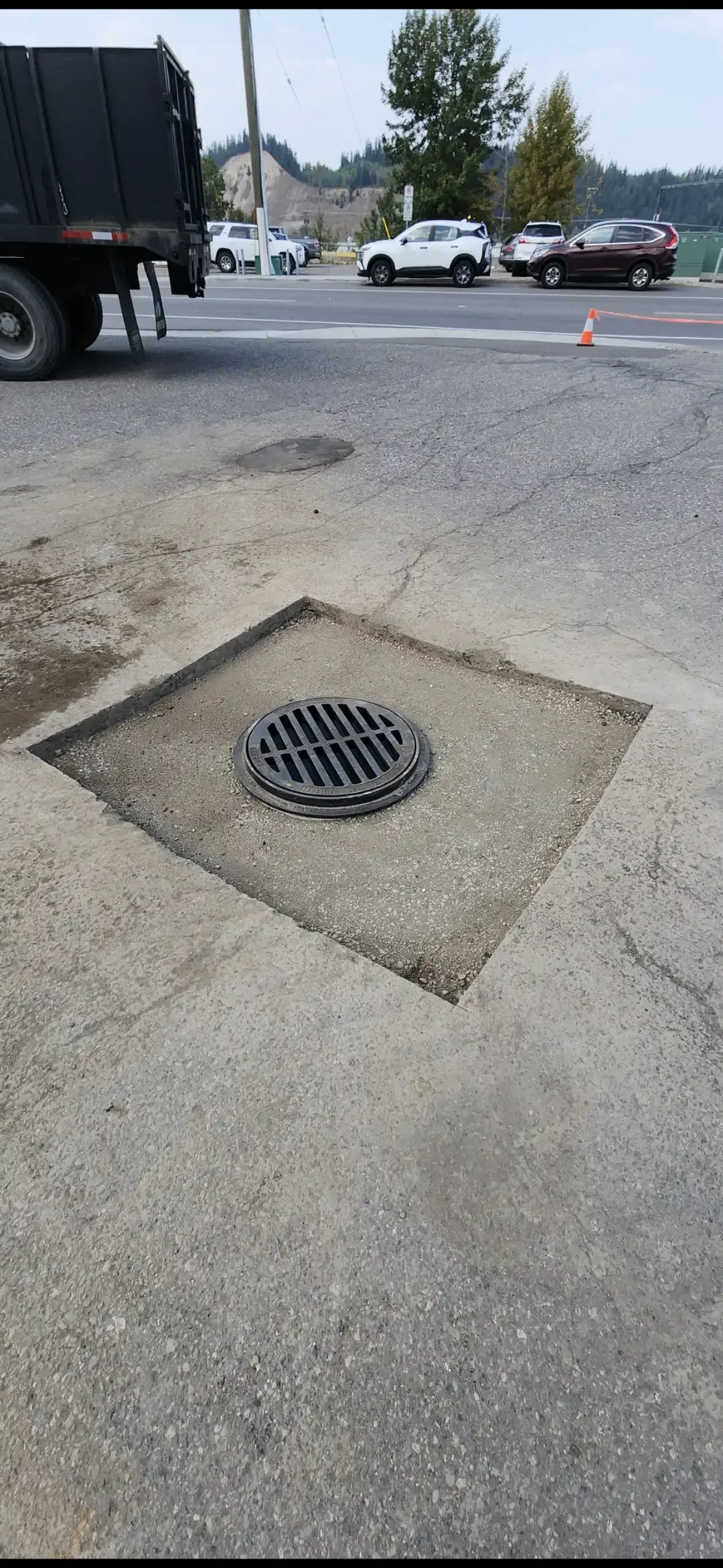 Cracked asphalt around storm drain before commercial pavement repair - Epic Pavement