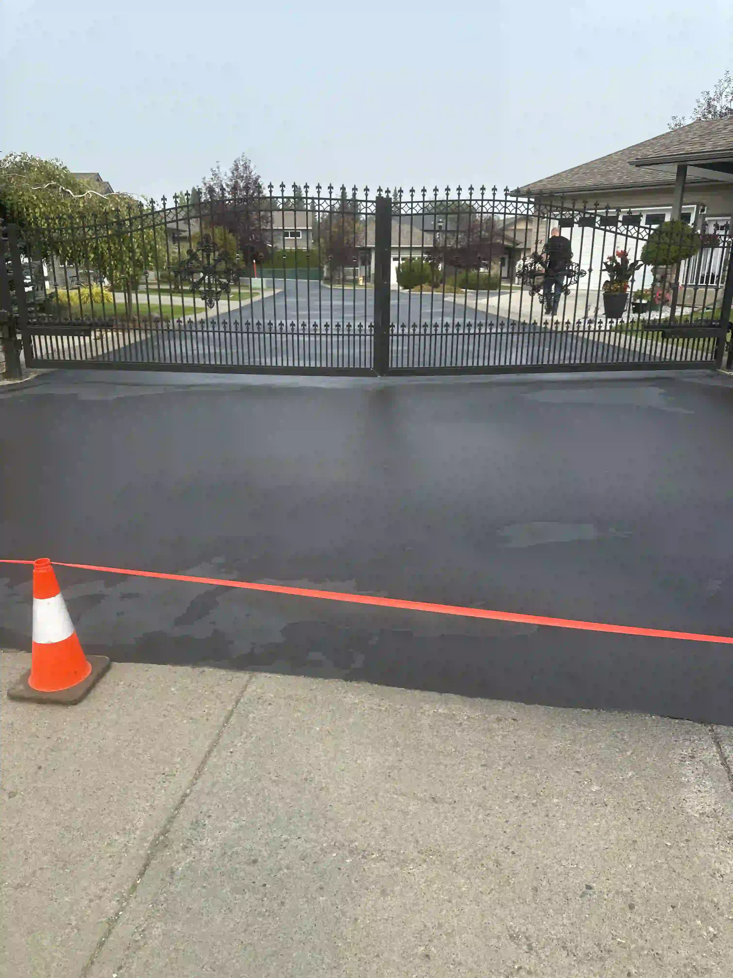Freshly repaved driveway on a residential street