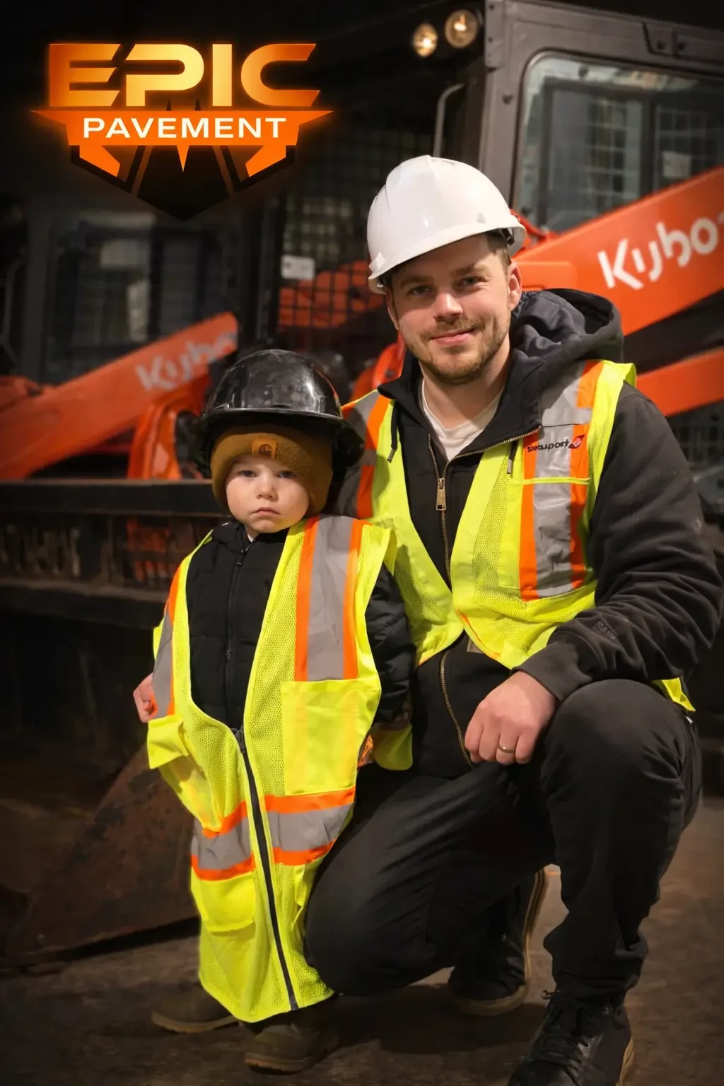 Owner of Epic Pavement with his child in front of Kubota equipment in Prince George BC