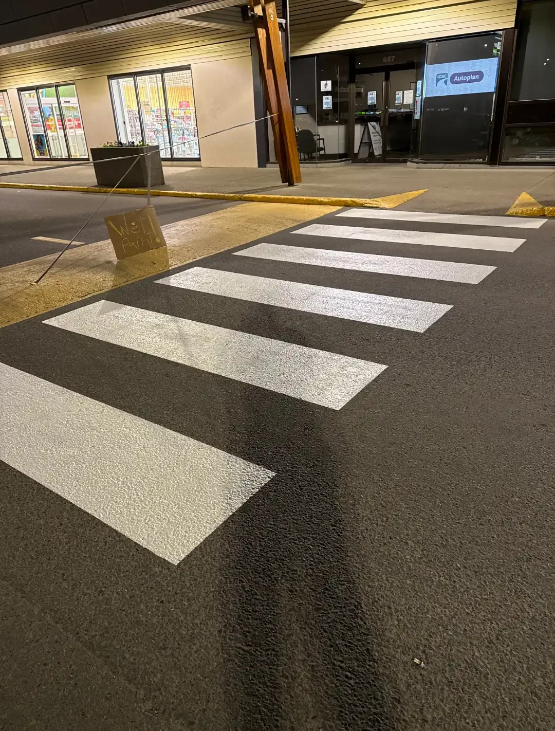Parking lot line painting at commercial property with fresh pedestrian crosswalk - Epic Pavement
