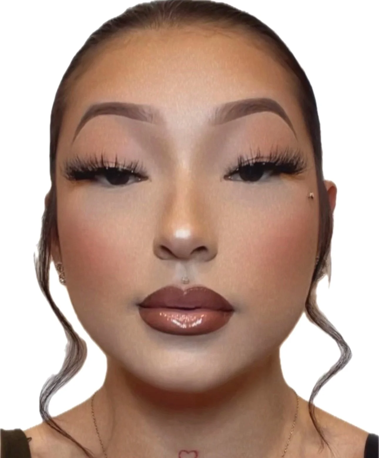 Close-up of a woman's face with makeup, including eye makeup, lip gloss, and a pierced nose with a small stud, against a white background.