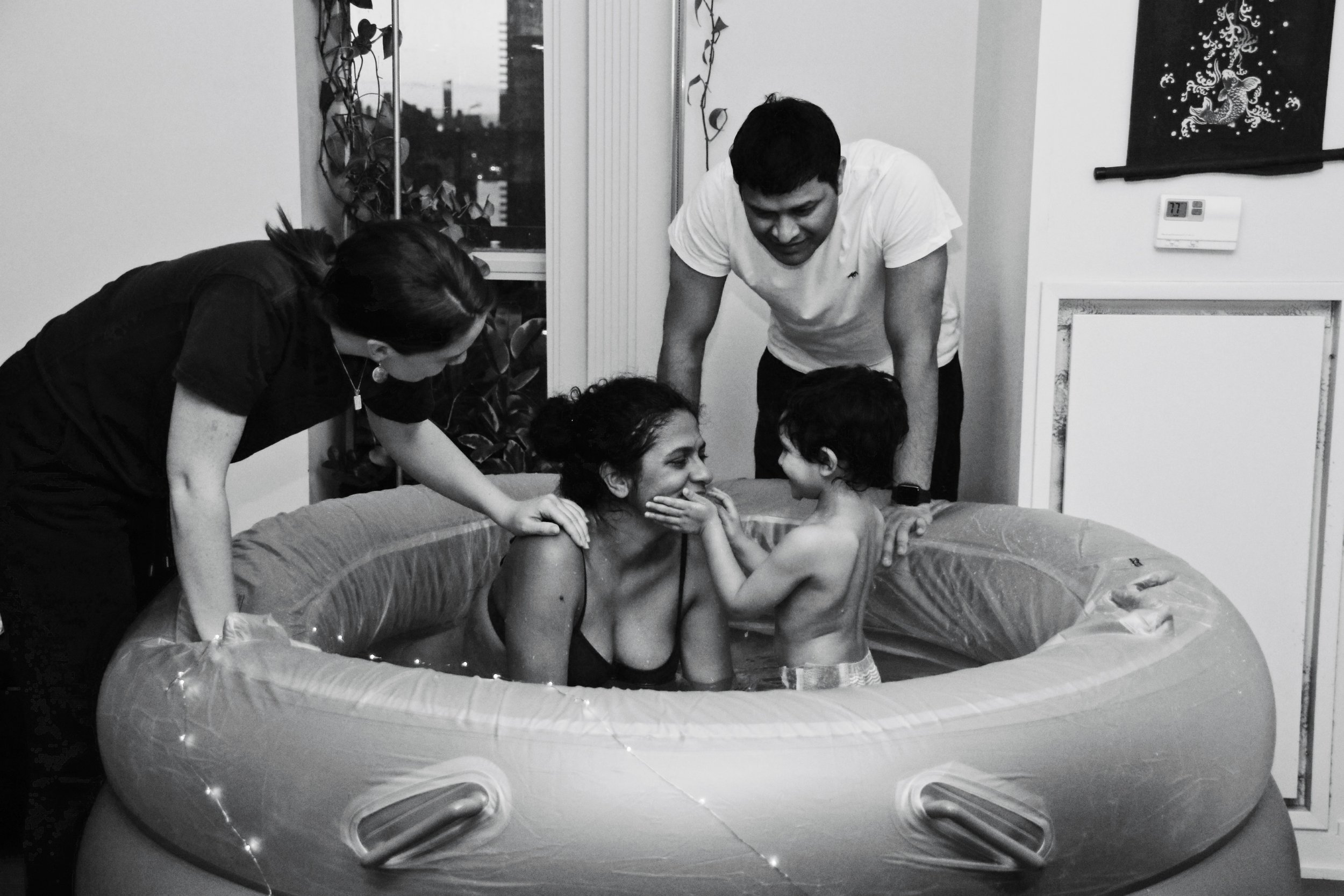 A Pregnant Toronto Mother Giving Birth with a Waterbirth Doula and Child in the Birthing Pool