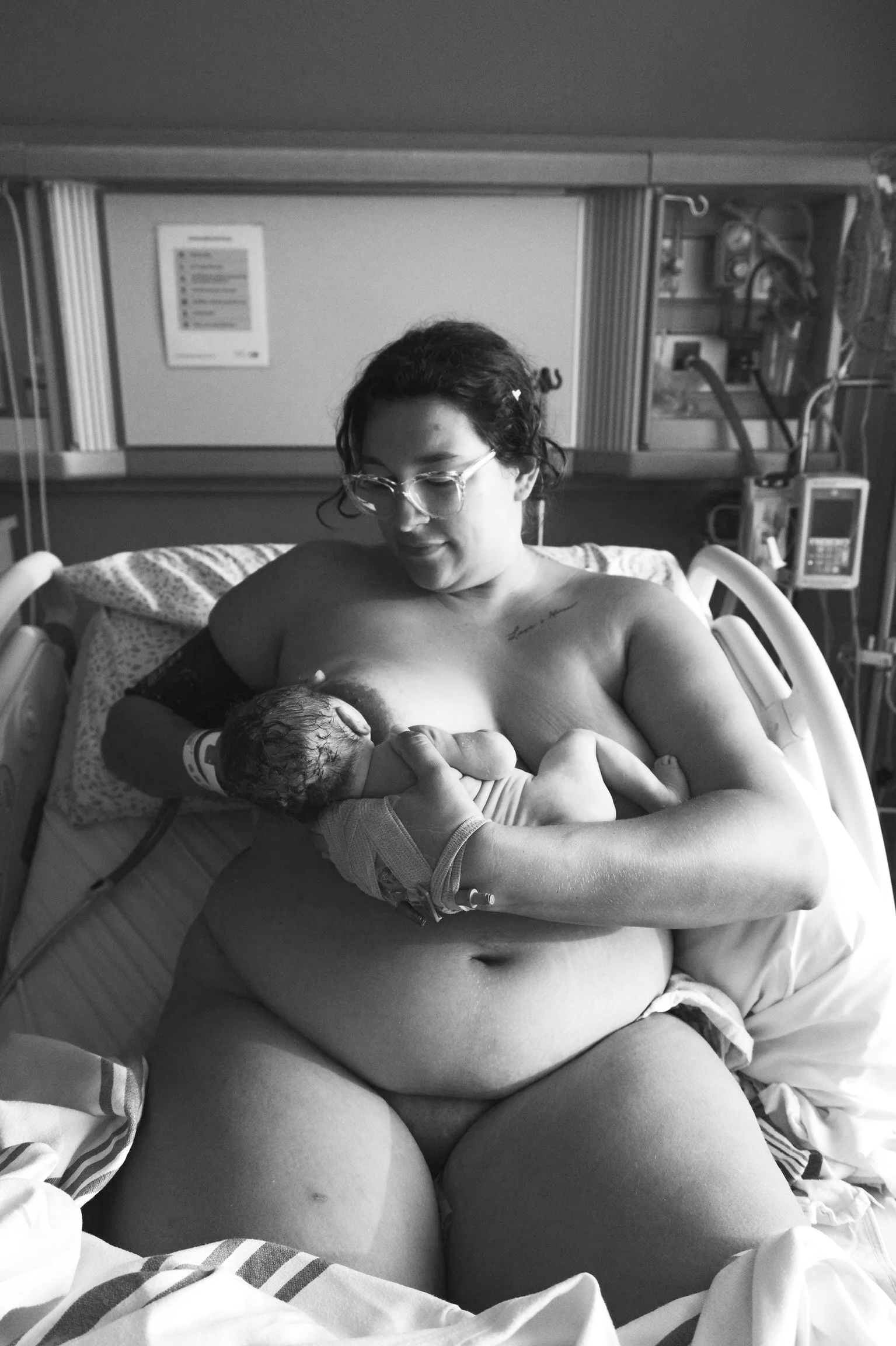 Doula providing lactation support in a hospital birth suite at Mount Sinai Labour & Delivery downtown Toronto