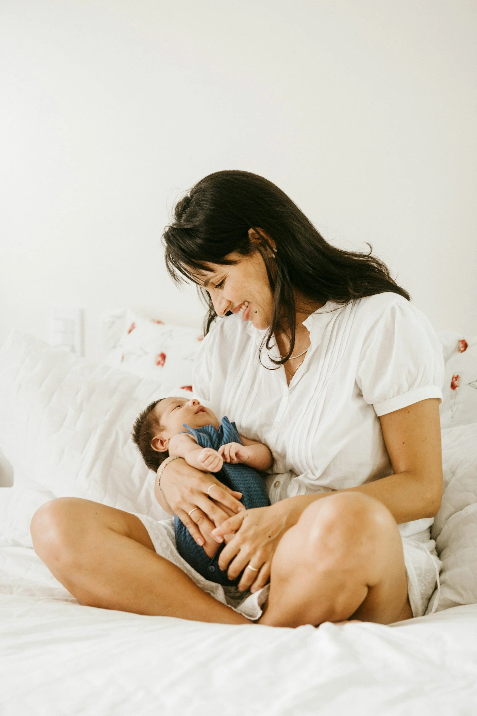 A new mom feels supported by her doula while holding her baby in Toronto