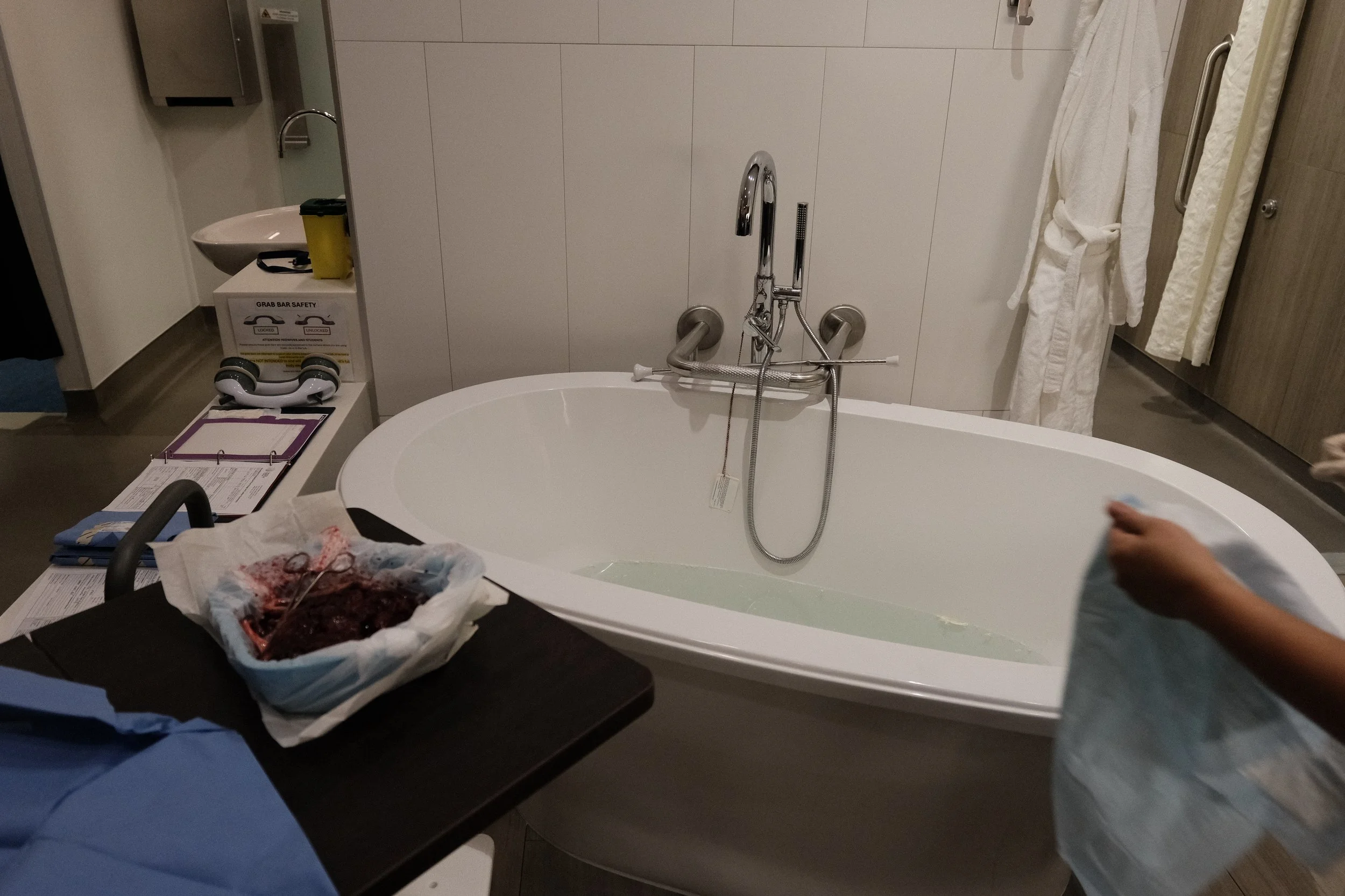 A spacious private birthing room at the Toronto Birth Centre featuring a large, built-in deep hydrotherapy tub prepared for a mindful water birth.