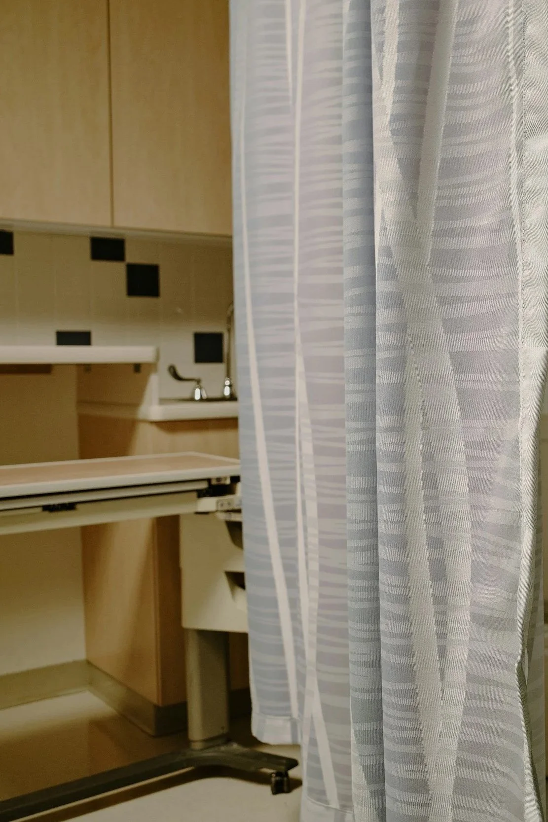 A softly lit private labor and delivery room at Mount Sinai Hospital Toronto, featuring a birth ball and dimmed lights for a mindful birth experience.