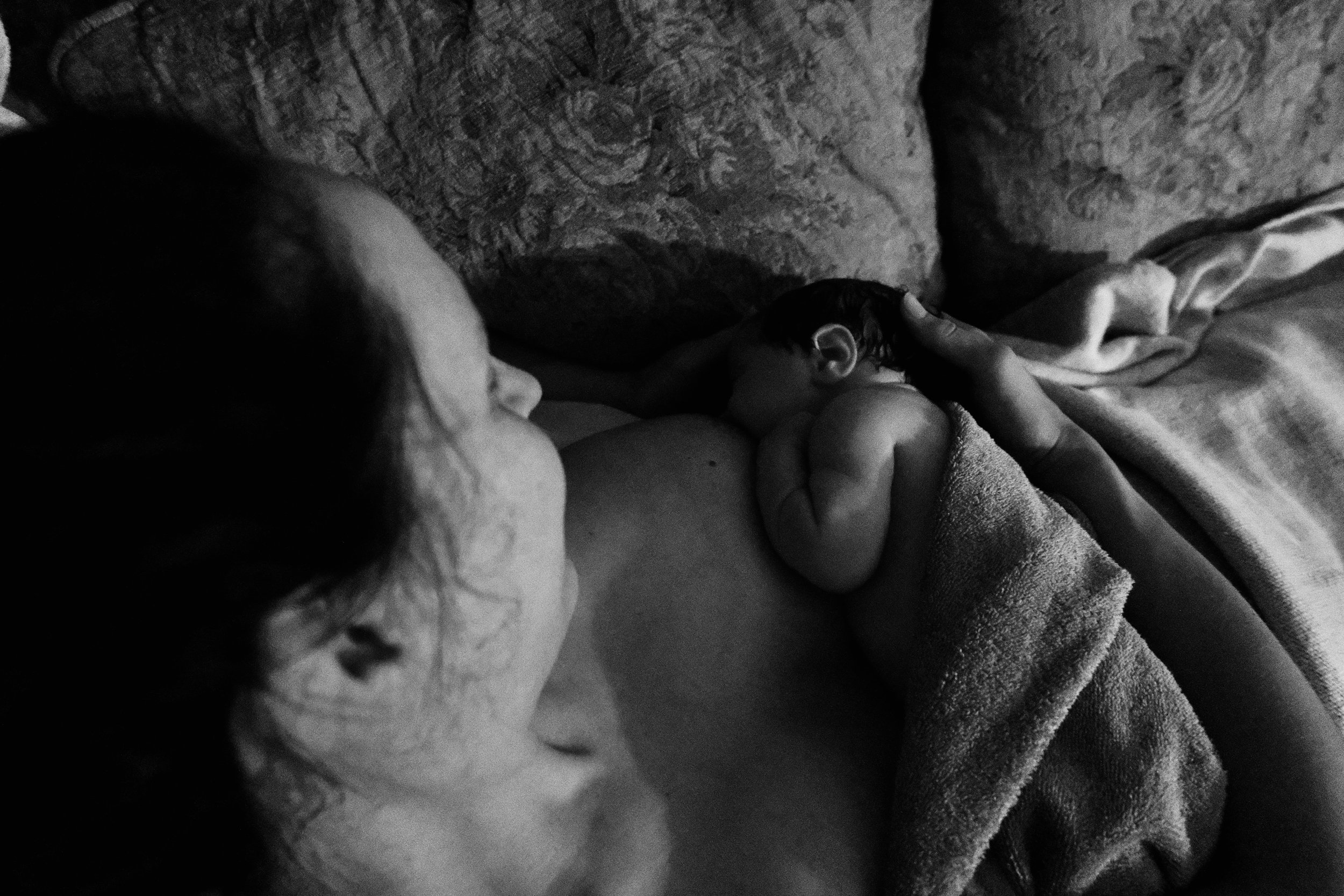 New Mom and Infant in the Golden Hours after birth captured by a birth photographer in Toronto