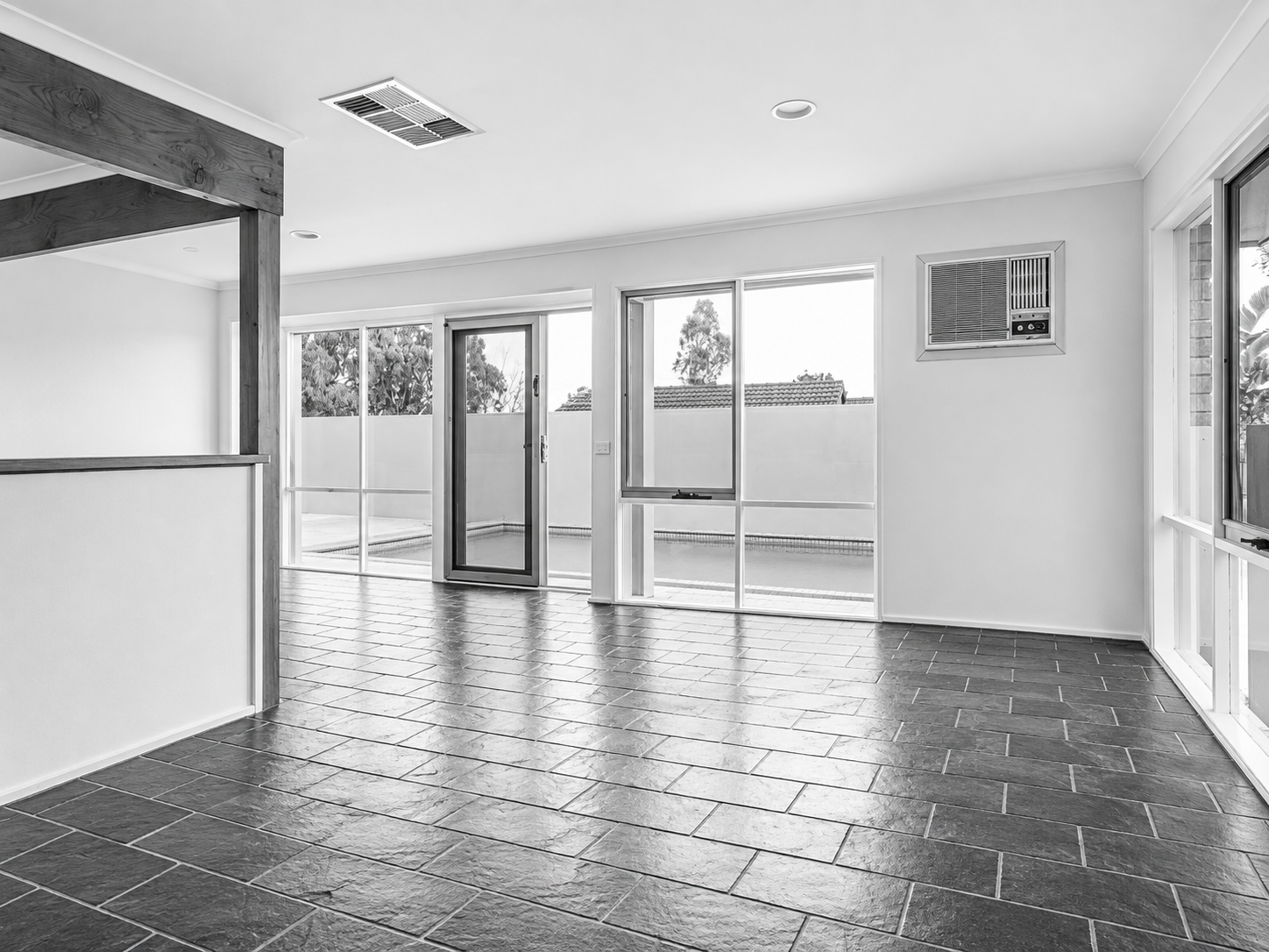 Pool House before the renovation: the open-plan rear living area with tiled floor, by FTLO Design