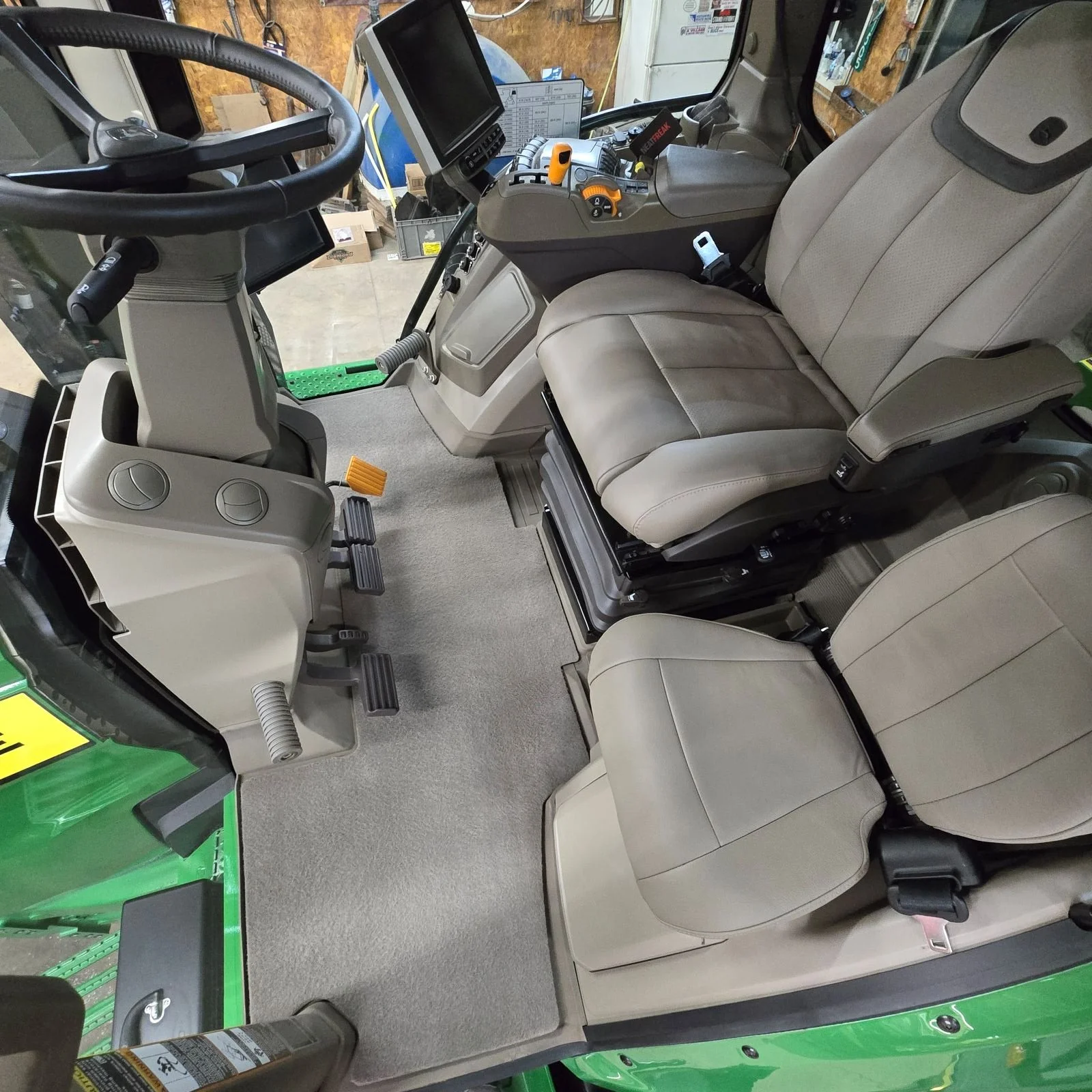 Inside of a tractor cab freshly cleaned and looking new.