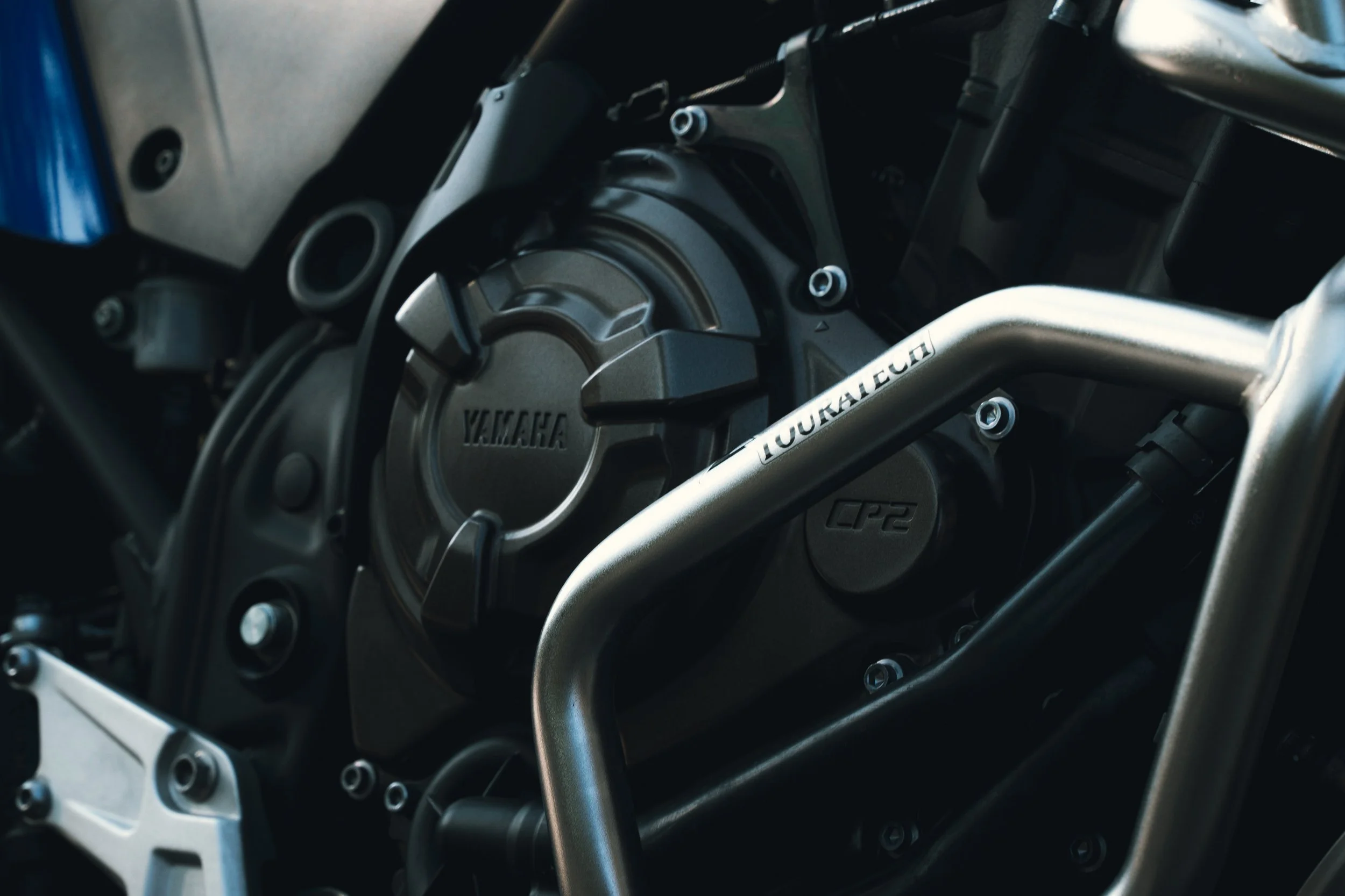 Close-up of a Yamaha motorcycle engine with a metallic frame and components.