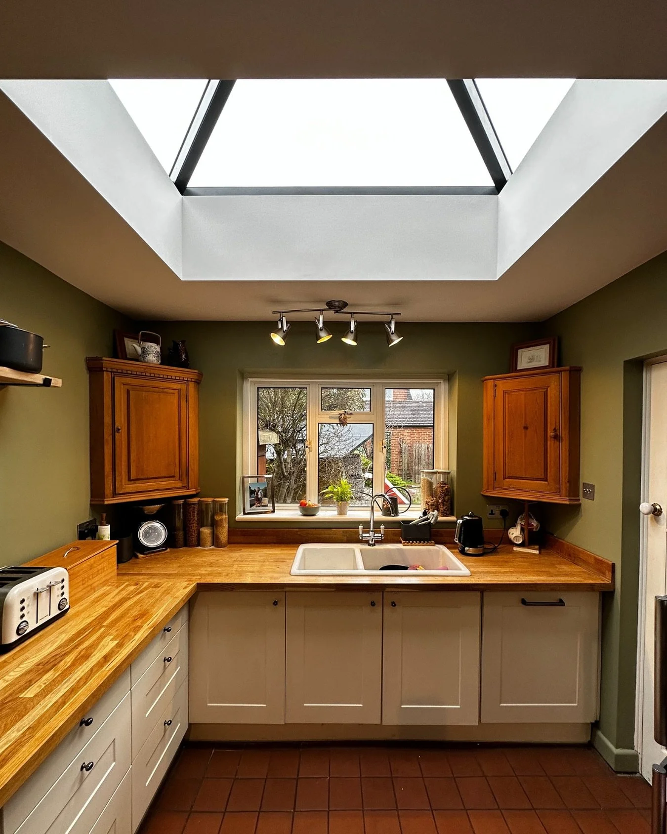 Natural light changes everything. We added a roof lantern to this north-facing kitchen, filling it with warmth and energy for a busy family full of life. Traditional styling, timber worktops, and fresh decorating bring it all together&mdash;bright, c