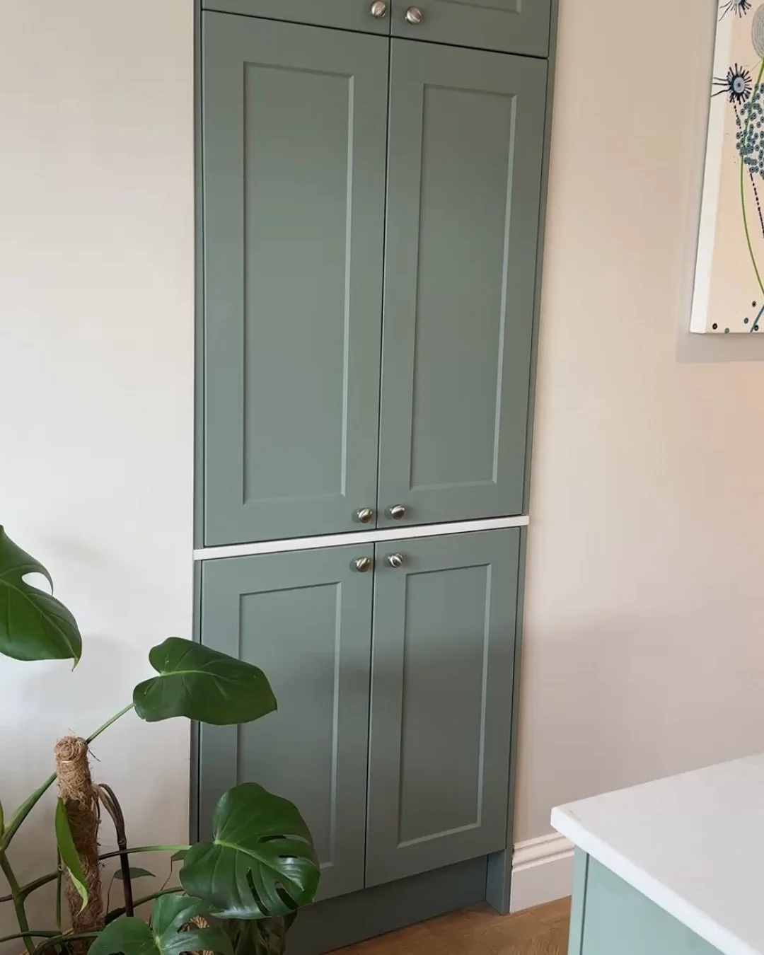 This alcove cabinet was built to house small appliances in a clean, practical way. A Web Bespoke carcass was combined with Wren OEM doors to match the kitchen. 

A quartz surface ties in with the rest of the space, and integrated sockets keep everyth
