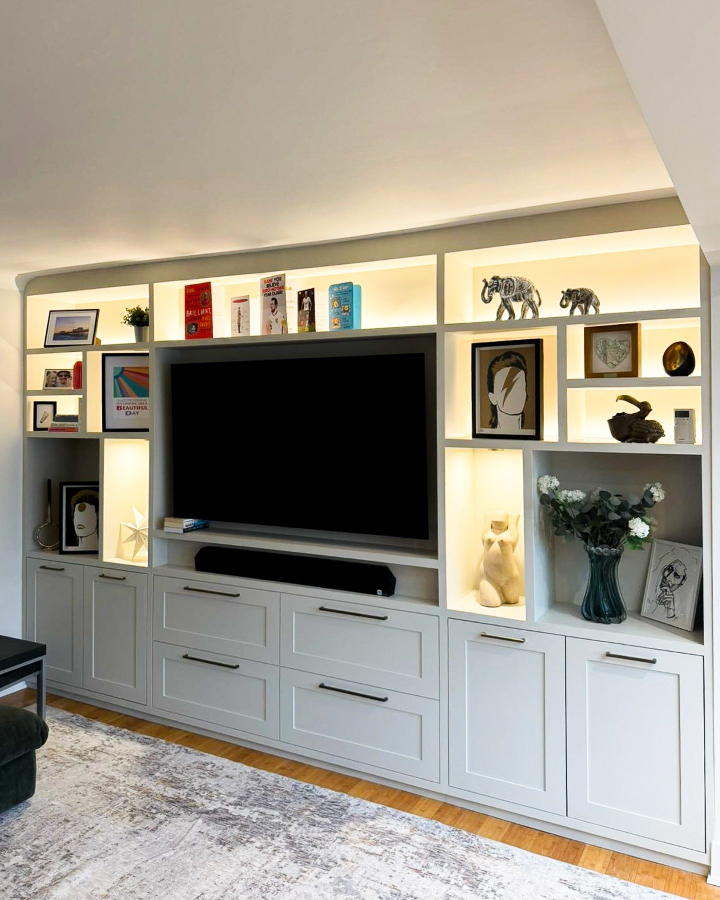 A media wall should not just hold a television. It should shape the room around it.&nbsp;

Here we combined concealed LED strips with recessed spotlights to create depth and highlight selected pieces, while leaving two larger recesses powered for lam