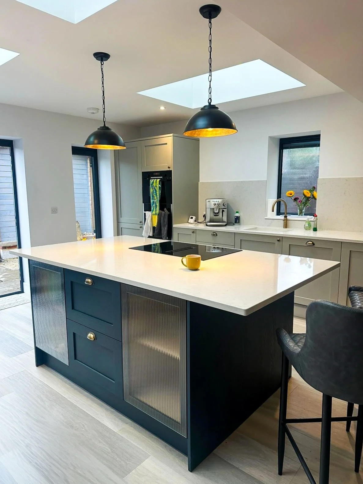This kitchen was planned long before it was installed. From the position of the island to how light enters the space, everything was set out early so it could be built properly. Rooflights bring daylight down over the worktop, while the layout keeps 