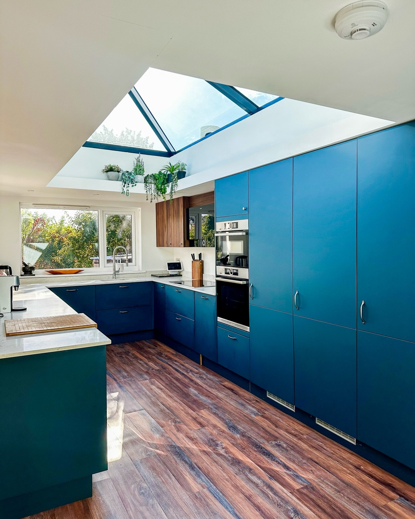 What used to be a garage is now the centre of the home at Hangleton View Drive. Coastal Trades reworked the layout to bring the kitchen into this new space, opening it back into the house with a goalpost frame so the room flows cleanly from one side 