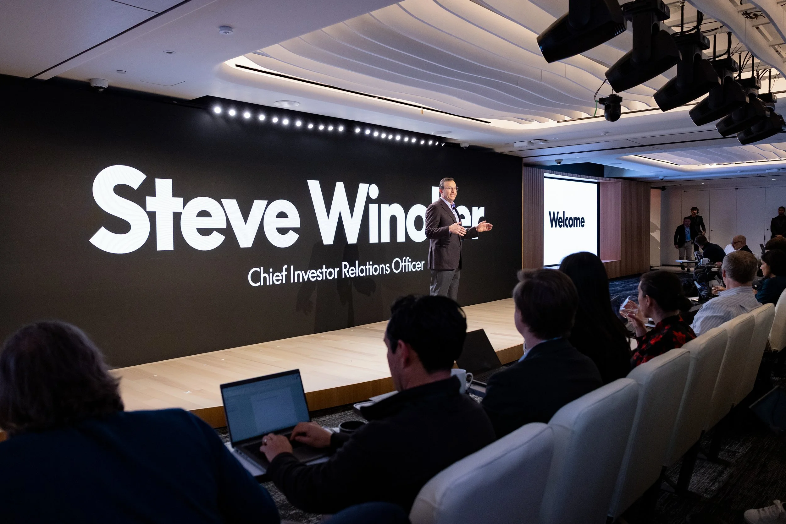 Chief Investor Relations Officer speaking on stage at an Investor conference in New York.