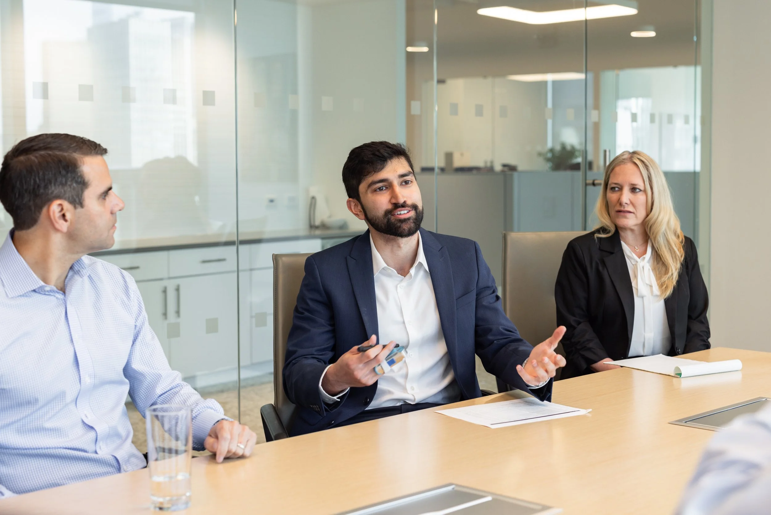 Branding shot of three employees at a meeting