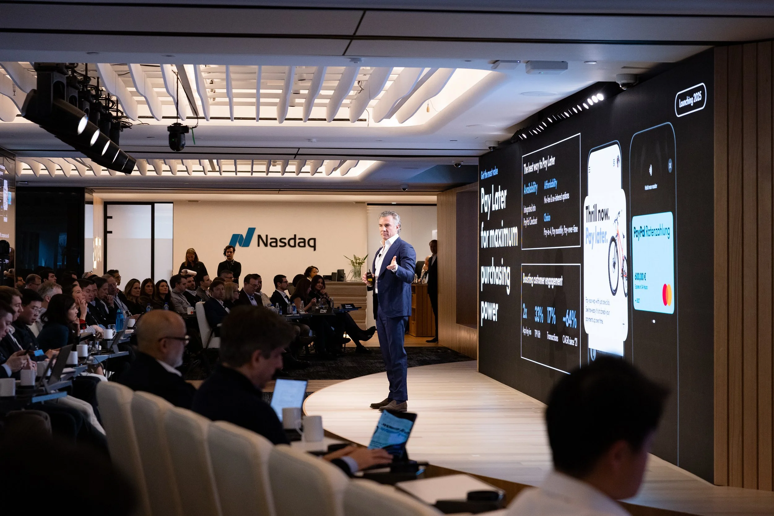 Male speaker on stage presenting to an audience