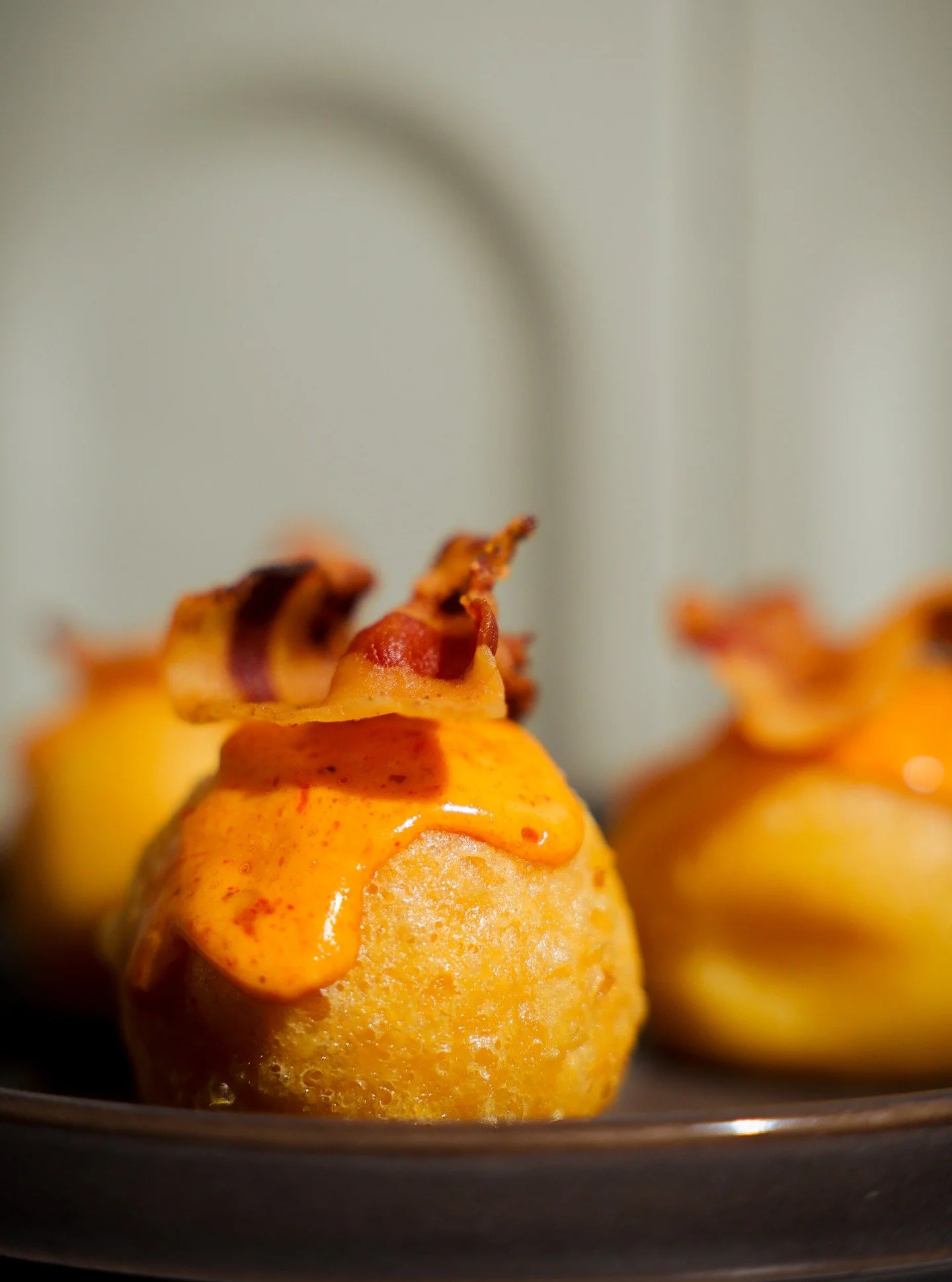 Naughtiness has never felt so comfy. Crispy grana balls, nduja lemon mayo, guanciale chips.