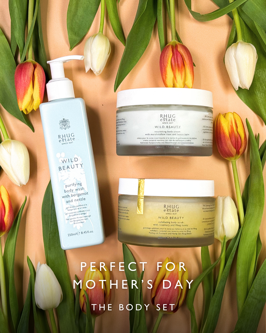 Three skincare products from Rhug estate surrounded by white, yellow, and red tulips on a peach background with the text 'Perfect for Mother's Day: The Body Set'.