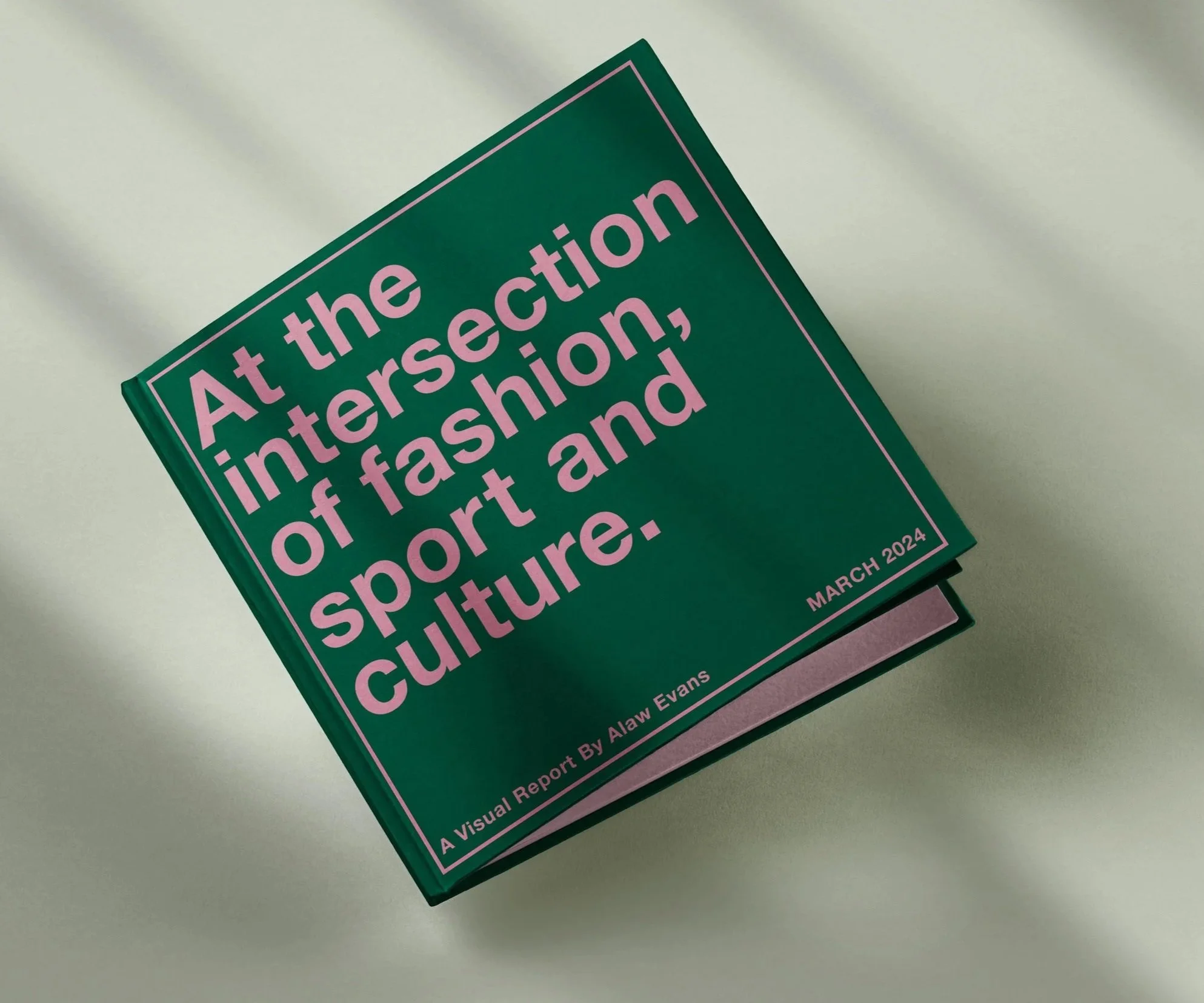 Close-up of a book titled "At the intersection of fashion, sport, and culture" by Alaw Evans, resting on a white surface.