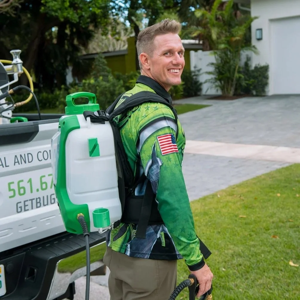 Buggify Pest Solutions technician carrying professional pest control sprayer while preparing residential ghost ant treatment service outside Boca Raton home.