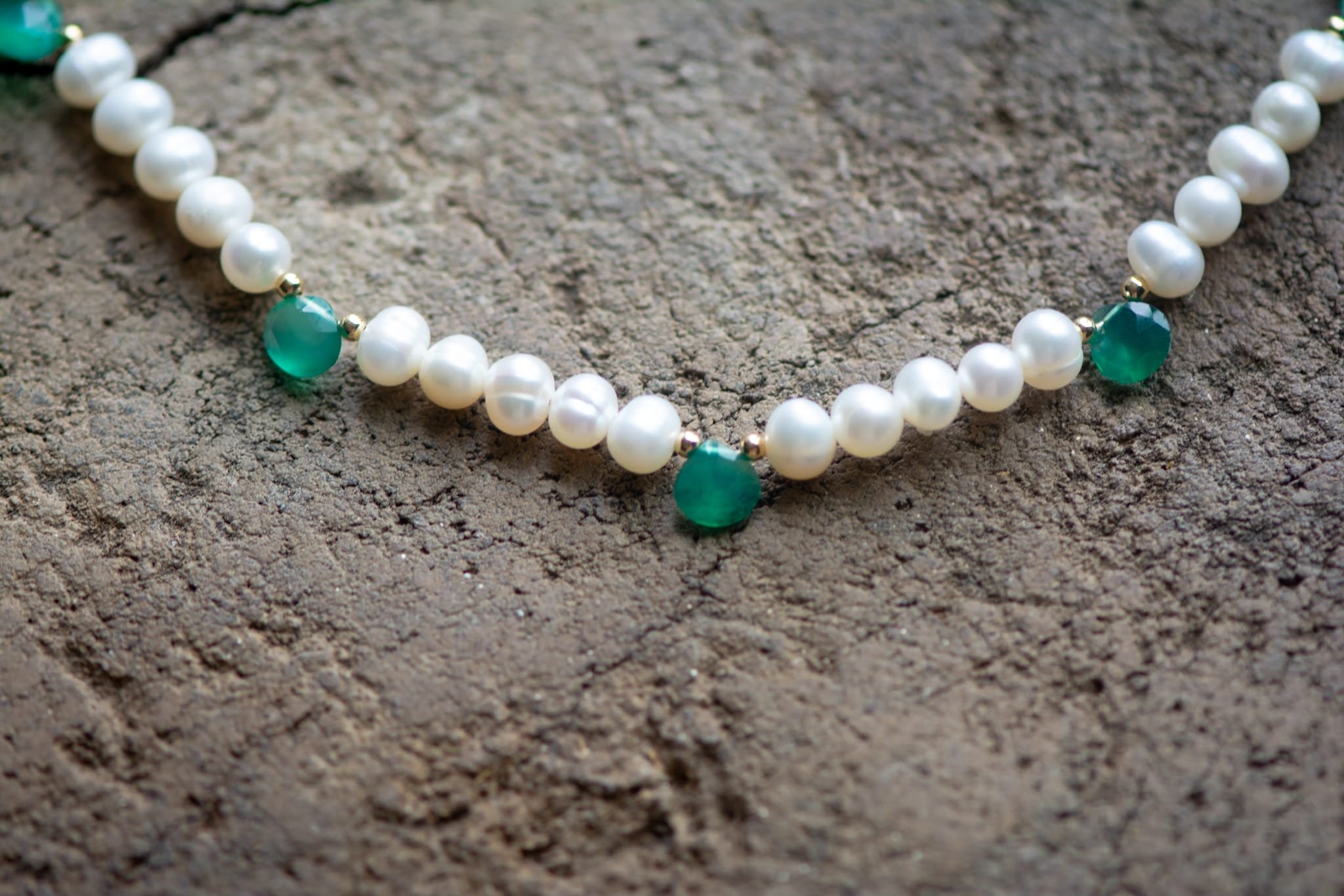 Green Onyx Briolet Necklace on stone.jpeg