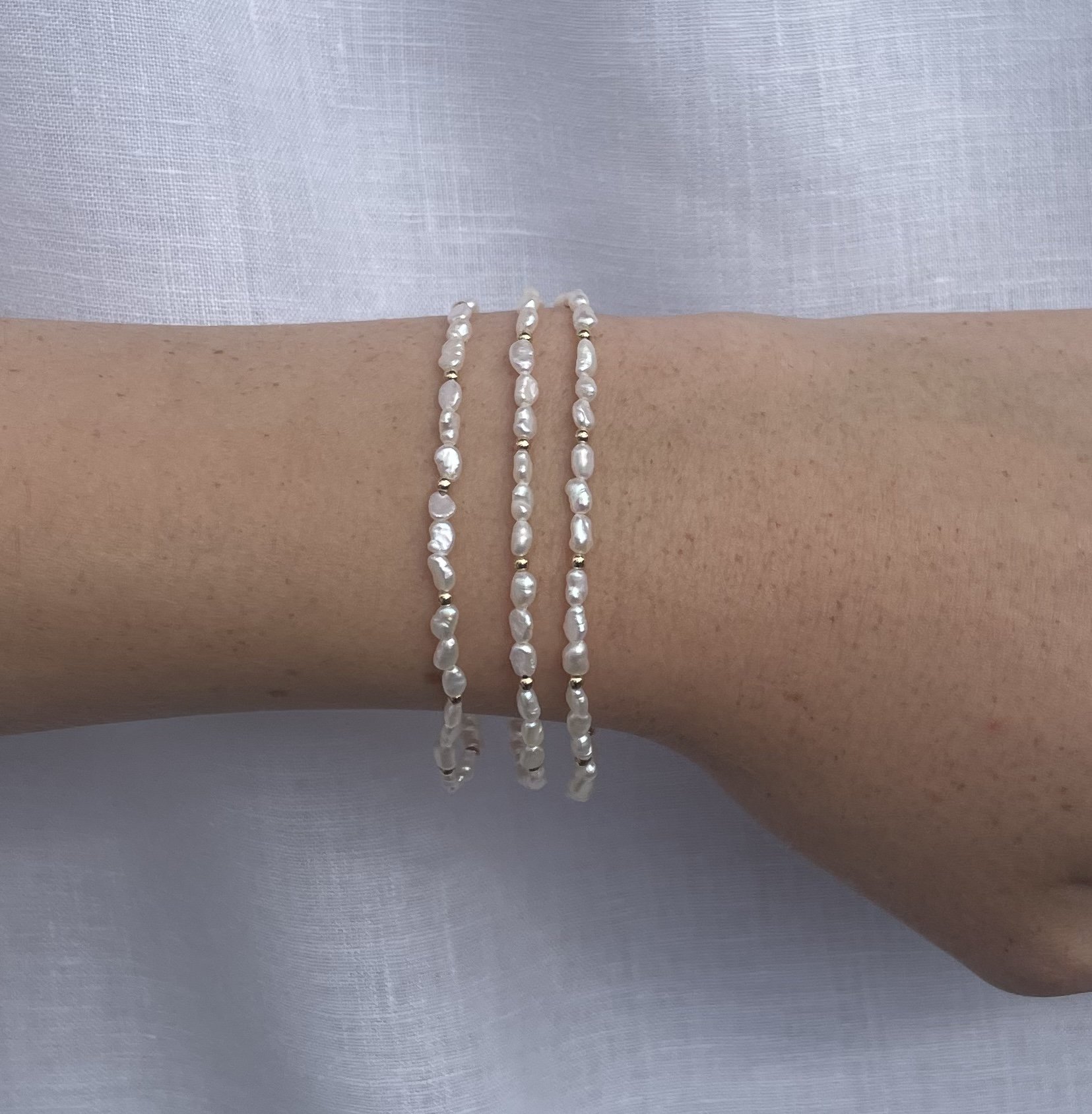 Isabel Tiny Freshwater Rice Pearl Stretch Bracelet muiltiple.jpeg