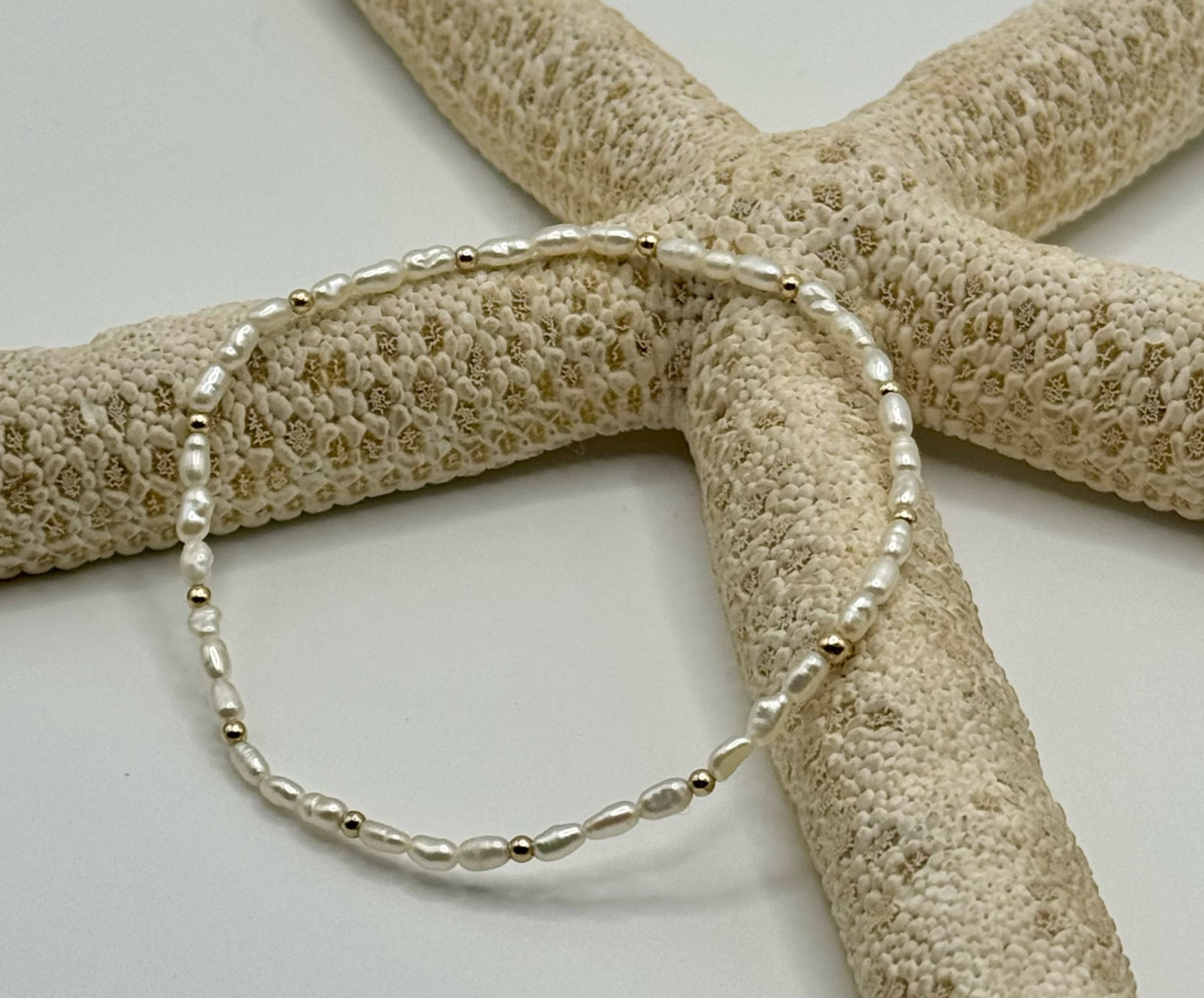 Isabel Tiny Freshwater Rice Pearl Stretch Bracelet with starfish.jpeg