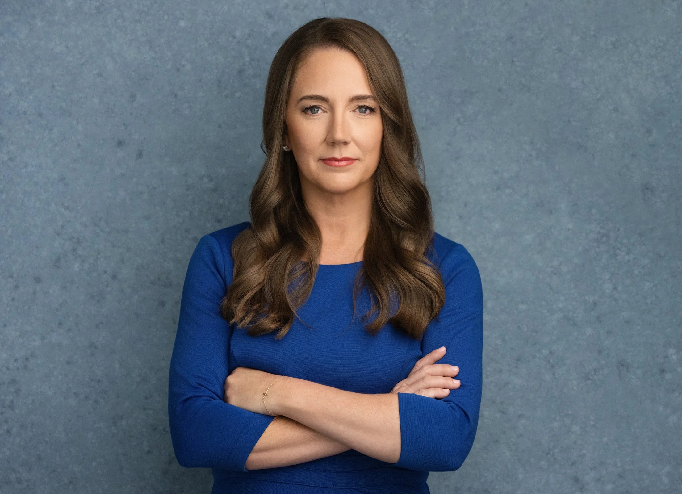 Headshot of Laurie Onorio in blue dress