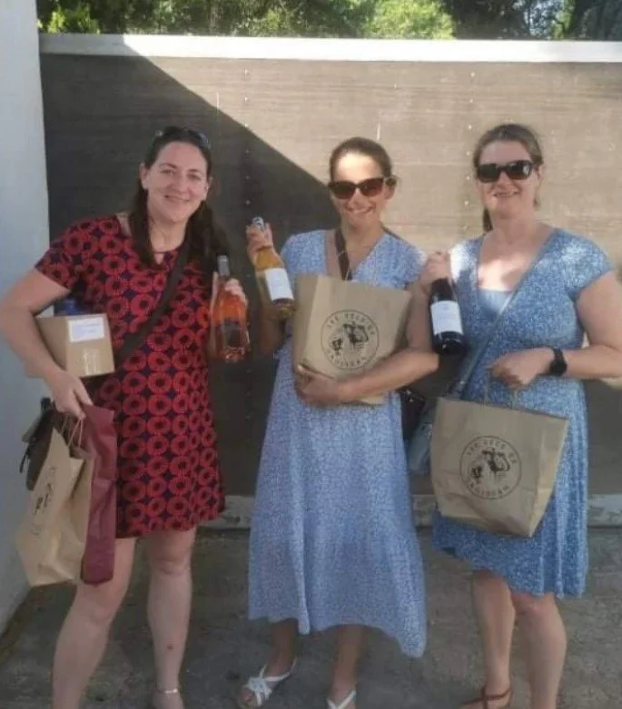 group of people enjoying wine tour after wine tasting in a winery