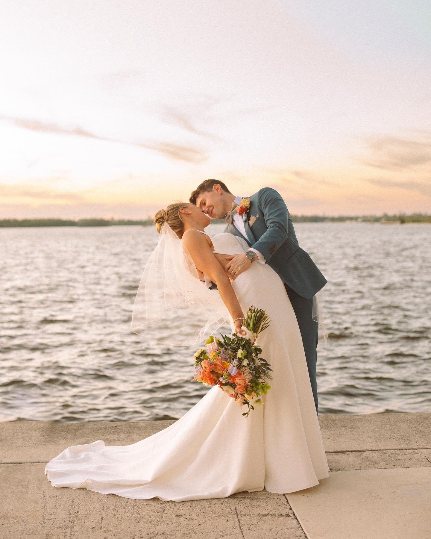 Liz and Tyler's carefree ceremony in Fort Myers, Florida was as picture perfect as you could imagine! Sun kissed skin, a golden hour glow, and a punchy, poppy floral palette of tulips, sweet peas, roses, ranunculus, and a splash of anemone, harmonizi