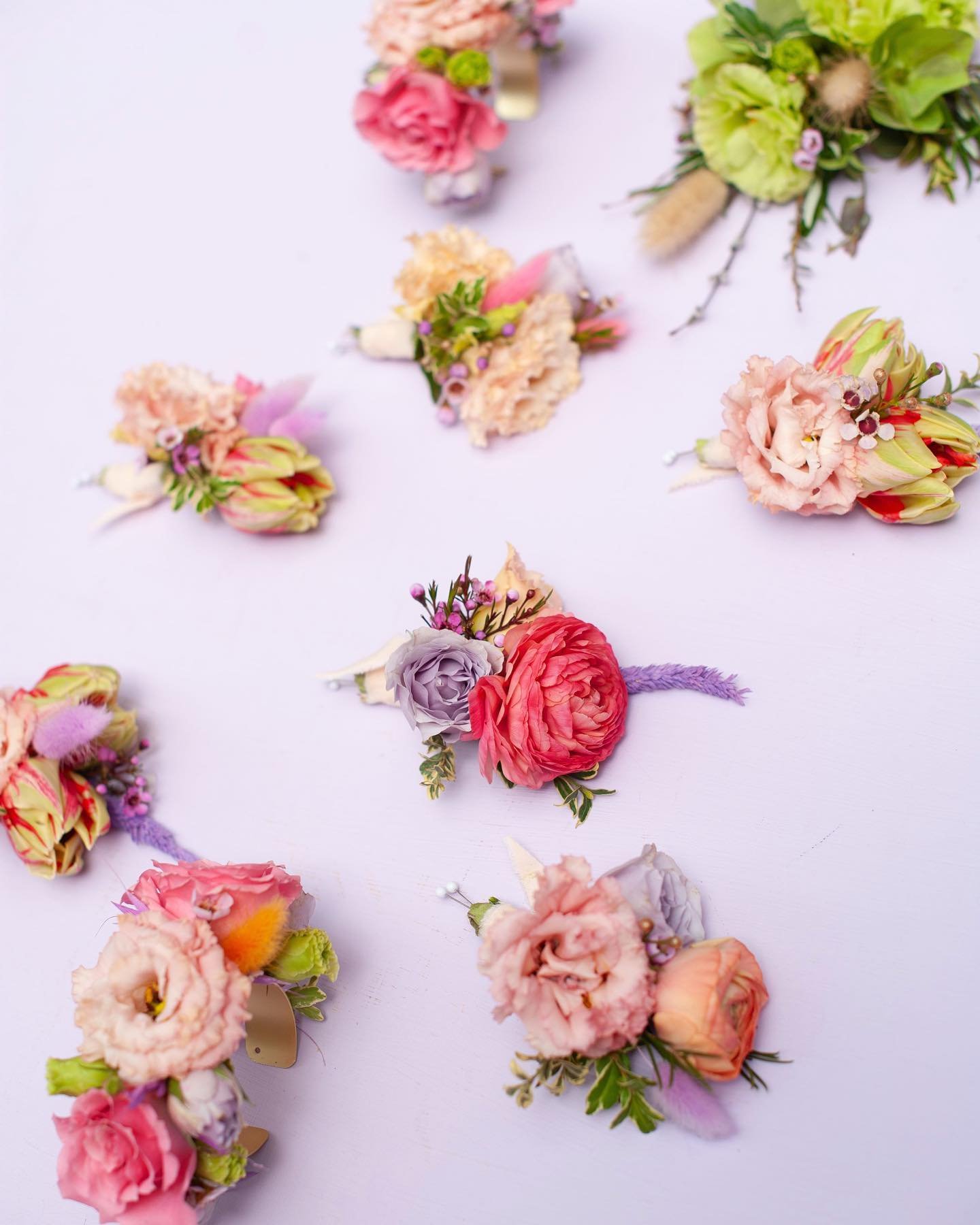 We believe corsages, boutonni&egrave;res, and pocket squares can be playful, fun, and unique just like the rest of your special day! This fun springy take on tulips, coral/lavender tones and playful dried elements is truly reinventing the wheel! At S