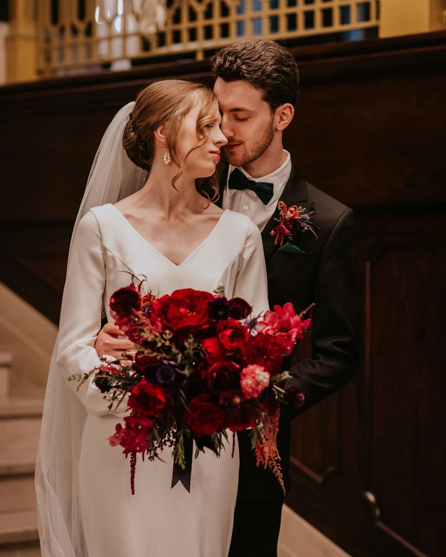 #WeddingWednesday: Ceila and Pablo's December wedding was a floral embrace of winter's darkest, moodiest tones. Raspberries, maroons, crimsons, emeralds, violets, and blues popped against the bright twinkling lights of the holidays and made their lib