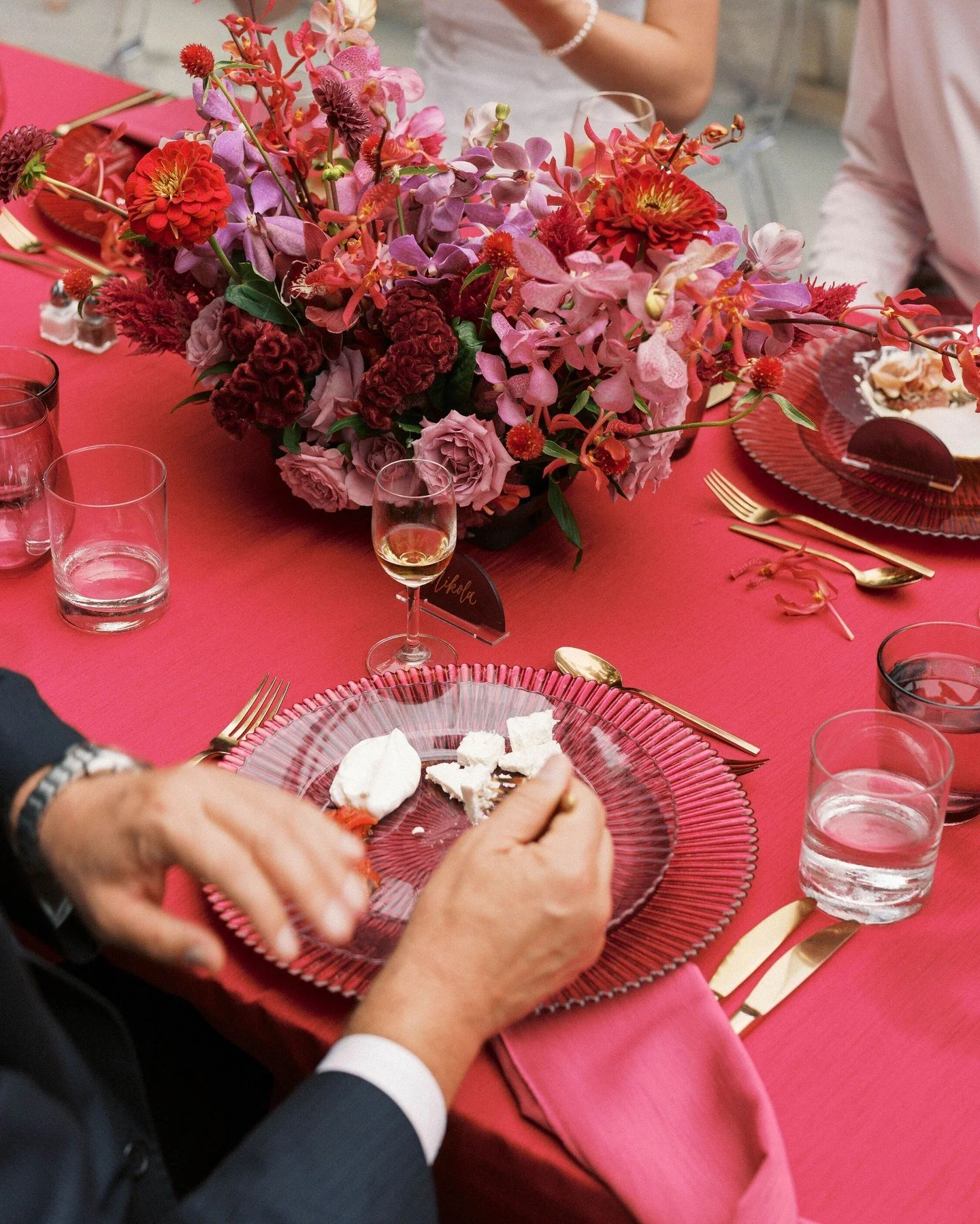 #WeddingWednesday: Let's talk about rehearsal dinner flowers. 🌸 

When your dearest friends and family are in town to celebrate your wedding, a table full of blooms (especially the punchy red and magenta tones Emily and Andrej chose) is a gorgeous w