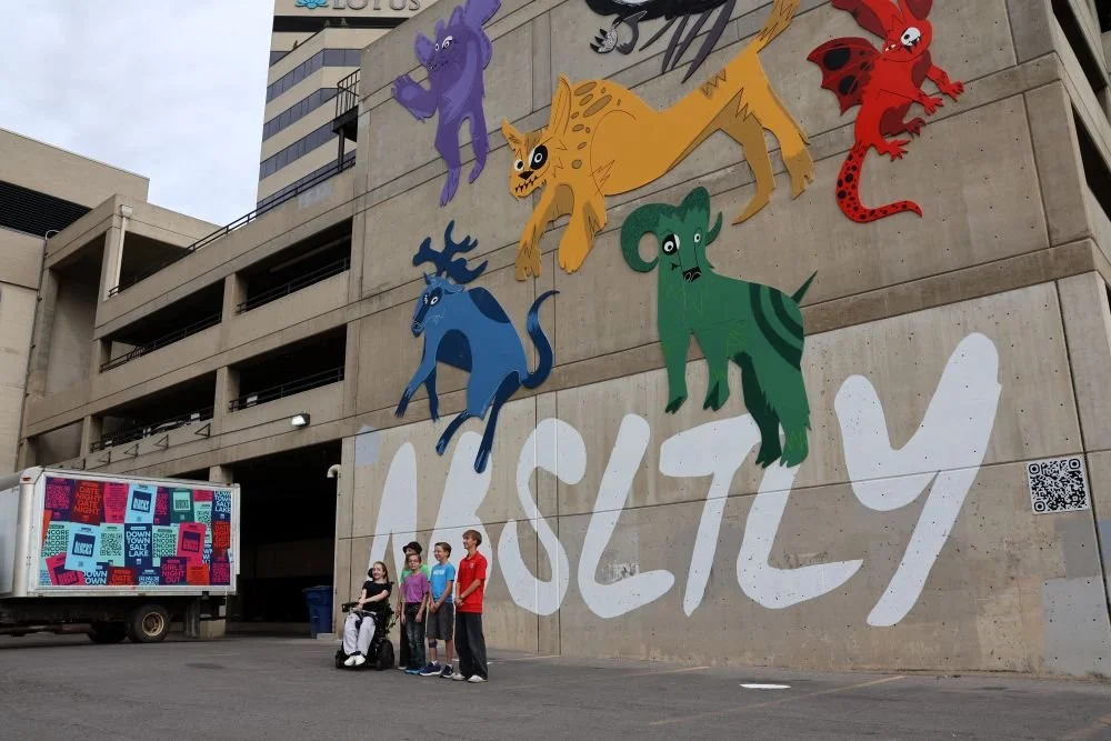 Artists posing in front of art.JPG