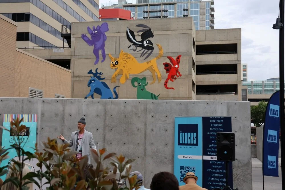 Dallas presenting in front of the wall.JPG
