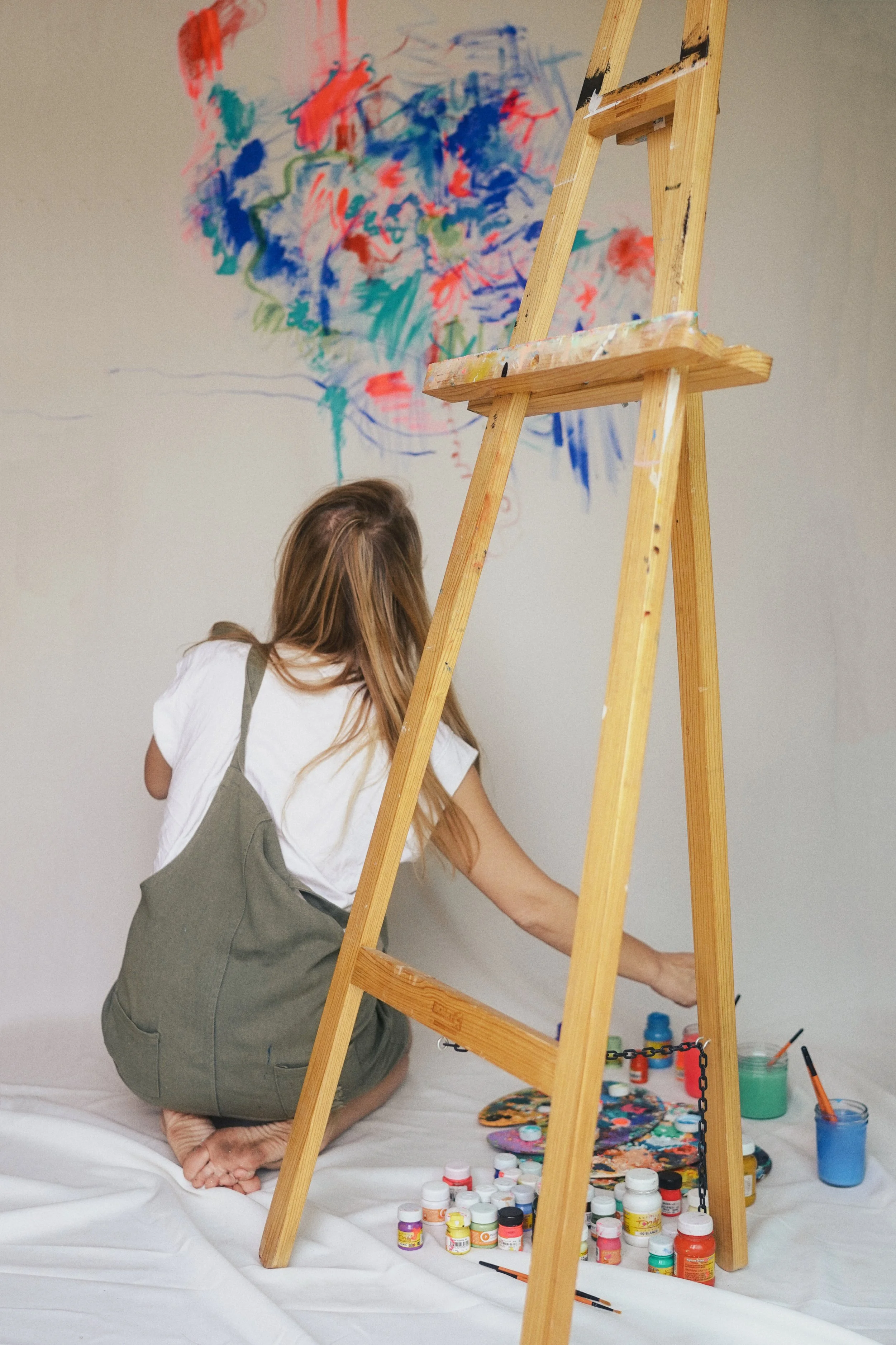 Anastasia Shi working in her Mexico City studio, surrounded by paintings and works in progress