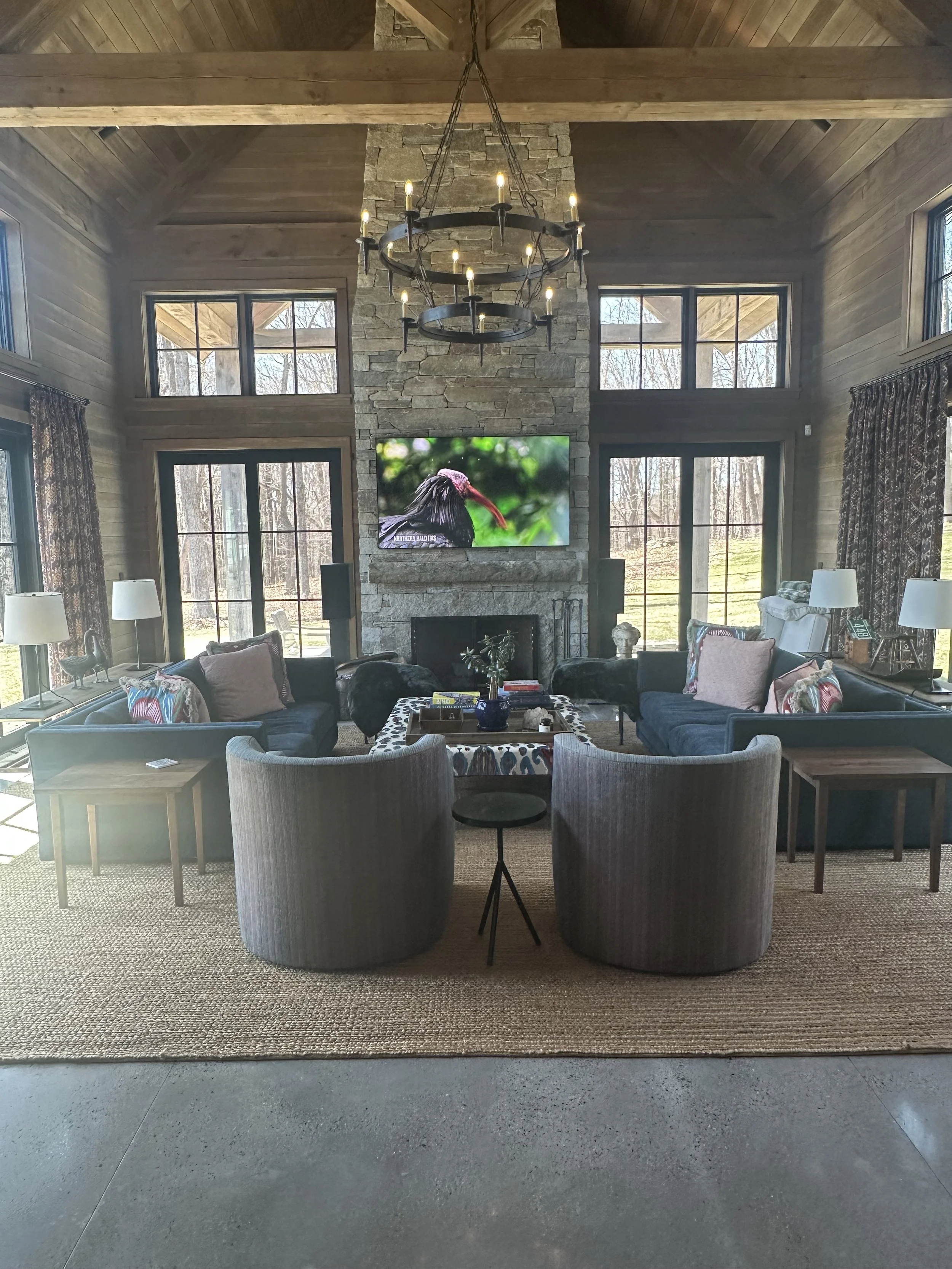 82" TV mounted on a 25' high granite fireplace. Surround system was built into this spacious barn with vaulted ceilings